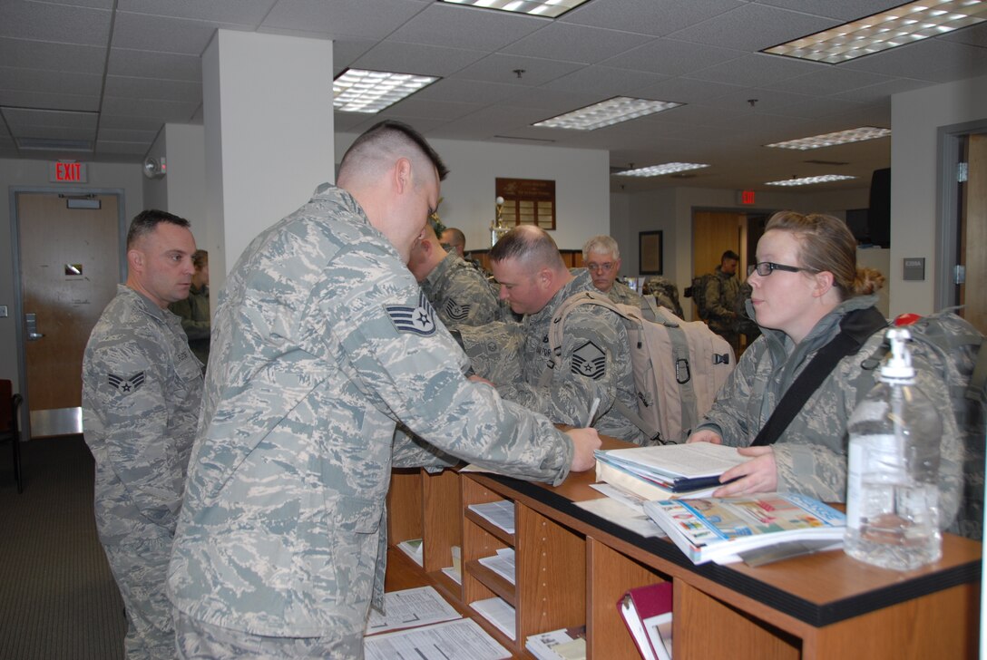 Staff Sgt. Dan Williams,155 Force Support Squadron, checks paperwork for Staff Sgt Lindsey Yardley, 155 Security Forces Squadron, on Jan. 9, 2010. Members of the 155 Security Forces Squadron from the Nebraska Air National Guard were outprocessing in support of Operation Iraqi Freedom. (Nebraska Air National Guard photo by Senior Master Sgt. Lee Straube) 