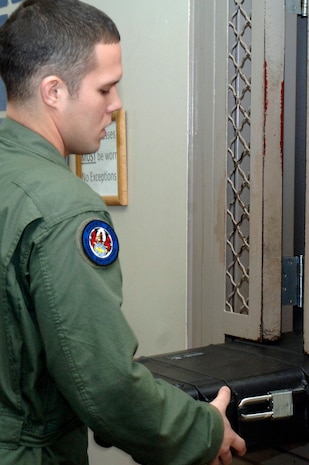 Staff Sgt. Joseph Burton receives his weapon's case at the 628th Security Forces Squadron armory prior to leaving on a mission to Haiti Jan 26, 2010, at Charleston AFB. During the first 11 days of Operation Unified Response, Charleston Ravens flew 76 out of the more than 250 AMC missions into Haiti. For the entire calendar year of 2009, Charleston Ravens flew 65 missions supporting high priority missions for both the Department of Defense and Department of State. Sergeant Burton is a Phoenix Raven with the 628 SFS.(U.S. Air Force photo/Staff Sgt. Marie Brown)