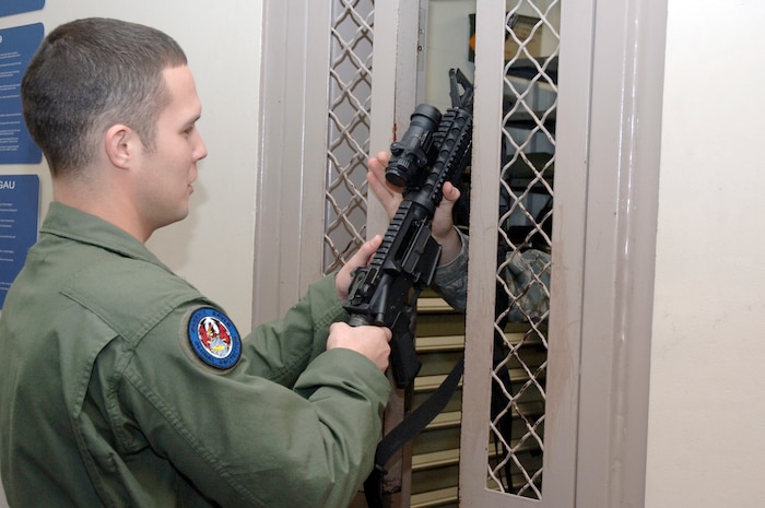 Staff Sgt. Joseph Burton receives his weapon at the 628th Security Forces Squadron armory prior to leaving on a mission to Haiti Jan 26, 2010, at Charleston AFB. During the first 11 days of Operation Unified Response, Charleston Ravens flew 76 out of the more than 250 AMC missions into Haiti. For the entire calendar year of 2009, Charleston Ravens flew 65 missions supporting high priority missions for both the Department of Defense and Department of State. Sergeant Burton is a Phoenix Raven with the 628 SFS. (U.S. Air Force photo/Staff Sgt. Marie Brown)