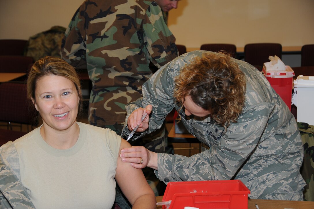 Lt. Angela Goldammer (right) from the 155 Medical Clinic administers the required H1N1 flu shot to Master Sgt. Tonja Buchholz from the 155 Contracting office during UTA on January 10, 2010.  (U.S. Air Force photo by MSgt. Vernon Moore) 