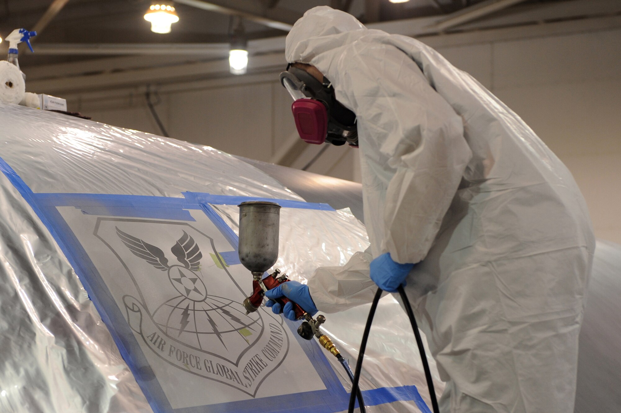WHITEMAN AIR FORCE BASE, Mo. -Airman 1st Class Kyle Miller, 509th Maintenance Squadron structural maintenance technician, sprays on the new Air Force Global Strike Command patch onto a B-2 Spirit in preparation for Whiteman's transfer of commands, Jan. 25, 2010. On Feb. 1, 2010, Whiteman AFB and its arsenal of 20 B-2 bombers will change commands from Air Combat Command to AFGSC. The mission of AFGSC is to "develop and provide combat-ready forces for nuclear deterrence and global strike operations -- safe -- secure -- credible to support the President of the United States and combatant commanders." (U.S. Air Force photo by Airman 1st Class Carlin Leslie) (Released)





