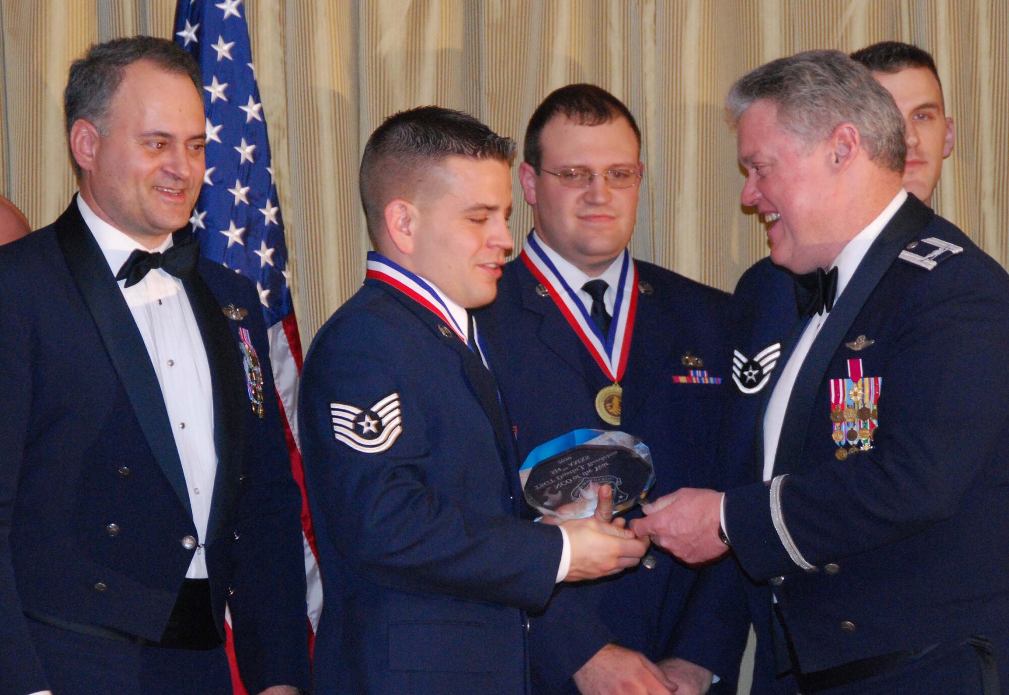 JOINT BASE MCGUIRE-DIX-LAKEHURST, N.J. - Tech. Sgt. Dustin J. Bordelon, middle, a C-17 Globemaster III communication/navigation specialist with the Reserve wing here, is named Noncommissioned Officer of the Year 2009. Winners of the annual awards were recognized by 514th Air Mobility Wing commander, Col. James L. Kerr, right and Command Chief Master Sgt. Michael Ferraro, left, during a banquet held Jan. 23 at the Community Center. (U.S. Air Force Photo/Master Sgt. Donna T. Jeffries)