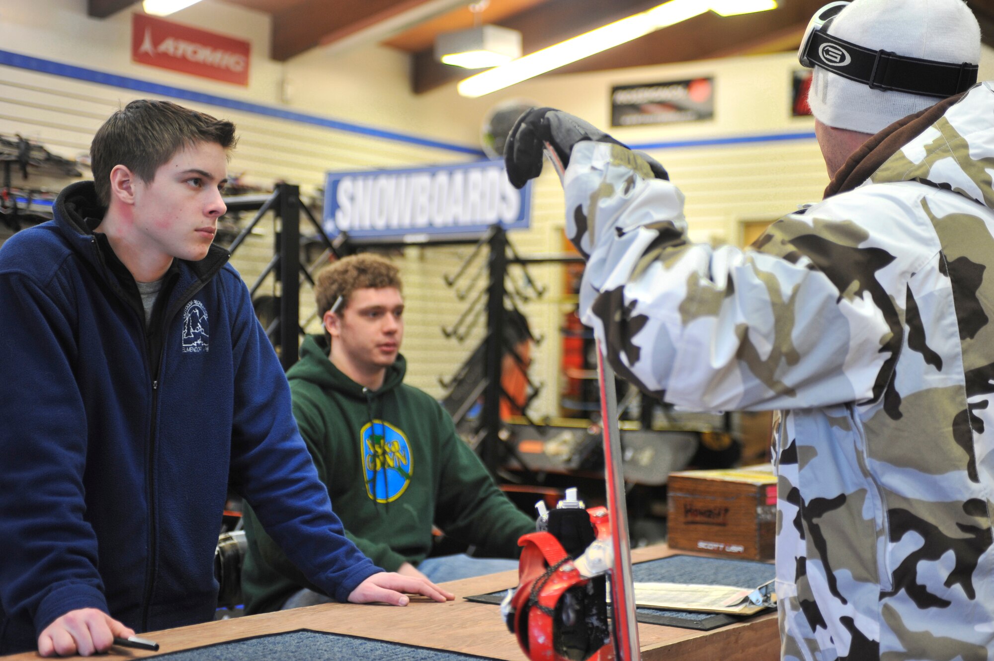 ELMENDORF AIR FORCE BASE, Alaska -- Aaron Perino and Zach Barkley assist a customer at the Hillberg Ski Lodge Jan. 23. Perino and Barkley spent the day handing out skiing and snowboarding equipment to patrons at the ski area. (Air Force photo by Senior Airman David Carbajal)