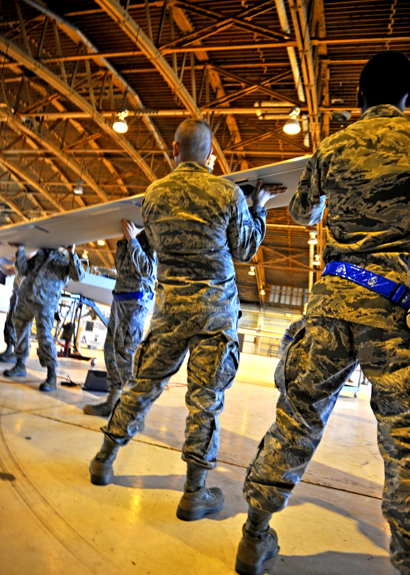 HOLLOMAN AIR FORCE BASE, N.M. -- Airmen from the 849th Aircraft Maintenance Squadron remove the right wing of an RQ-1 Predator, Jan 17. The Airmen were dissembling and packaging an RQ-1 for departure in support of Operation Unified Response. Team Holloman is preparing personnel and supplies to send to Haiti after it was rocked by a 7.0-magnitude earthquake Jan. 12. (U.S. Air Force photo by Staff Sgt. Anthony Nelson Jr.)
