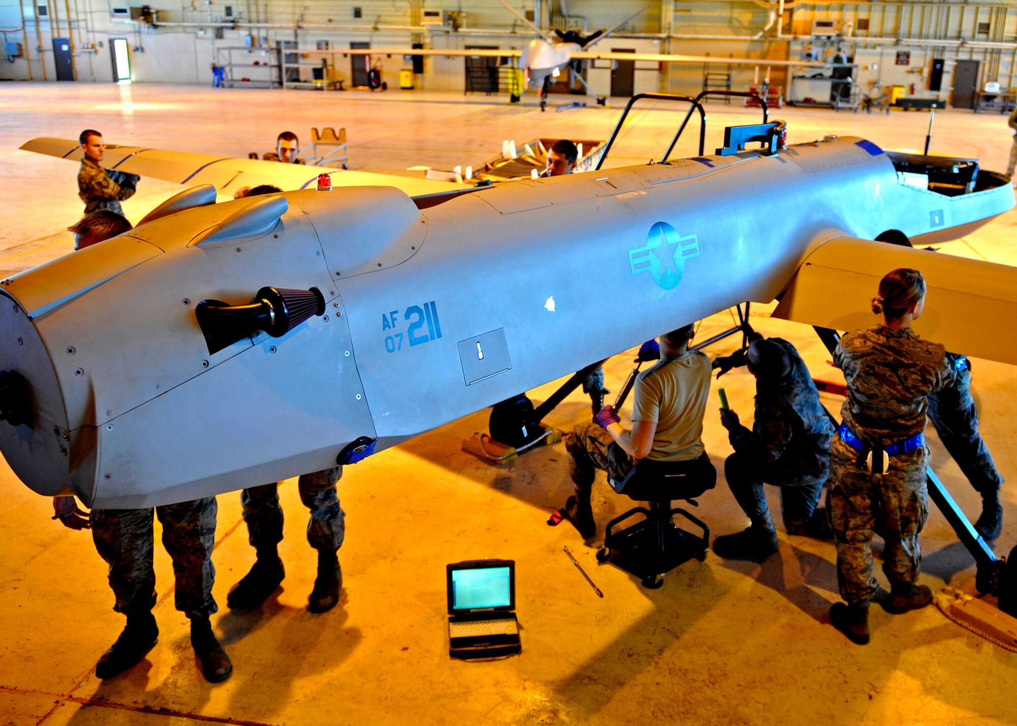 HOLLOMAN AIR FORCE BASE, N.M. -- Airmen from the 849th Aircraft Maintenance Squadron disassemble an RQ-1 Predator for departure in support of Operation Unified Response, Jan 17. Units from across the base have been tasked to prepare personnel and assets to deploy in support of Haiti relief efforts. (U.S. Air Force photo by Staff Sgt. Anthony Nelson Jr.)
