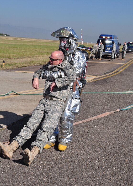 Team Soto Cano firefighter drags mock crash victim away from a CH-47 to a casualty collection point during a major accident response exercise Jan. 22 on the Soto Cano AB, Honduras flightline.  Agencies from across Soto Cano AB participated in the MAREX to evaluate their response procedures and improve their skill sets. (U.S. Air Force photo/Staff Sgt. Bryan Franks)