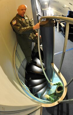 OFFUTT AIR FORCE BASE, Neb. - Lt. Col. James D'Amour arrives at the flight deck as  Lt. Col. Tim Carter makes his way up the stairs of an E-4B. The E-4B serves as the National Airborne Operations Center for the president, secretary of defense and chairman of the Joint Chiefs of Staff. It was delivered to the Air Force for operational use in December 1974 and assumed alert status from the EC-135J 35 years ago this month. U.S. Air Force photo by Lance Cheung