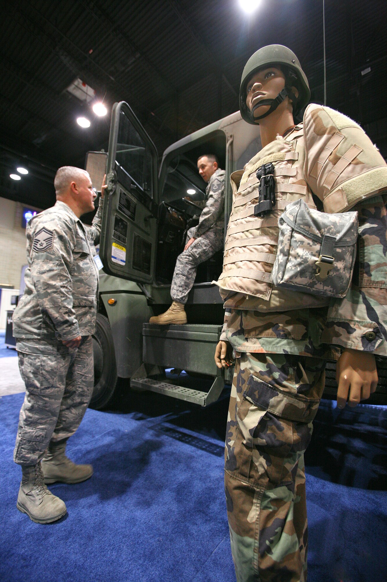An M915 semi-tractor trailer was part of the 342nd Training Squadron's display at the 2010 Air Education and Training Command symposium Jan. 14 and 15. The display was manned by Senior Master Sgt. Brian Hubbard (standing) and Master Sgt. Chris Dunstone, both with the 342nd TRS. (U.S. Air Force photo/Robbin Cresswell) 