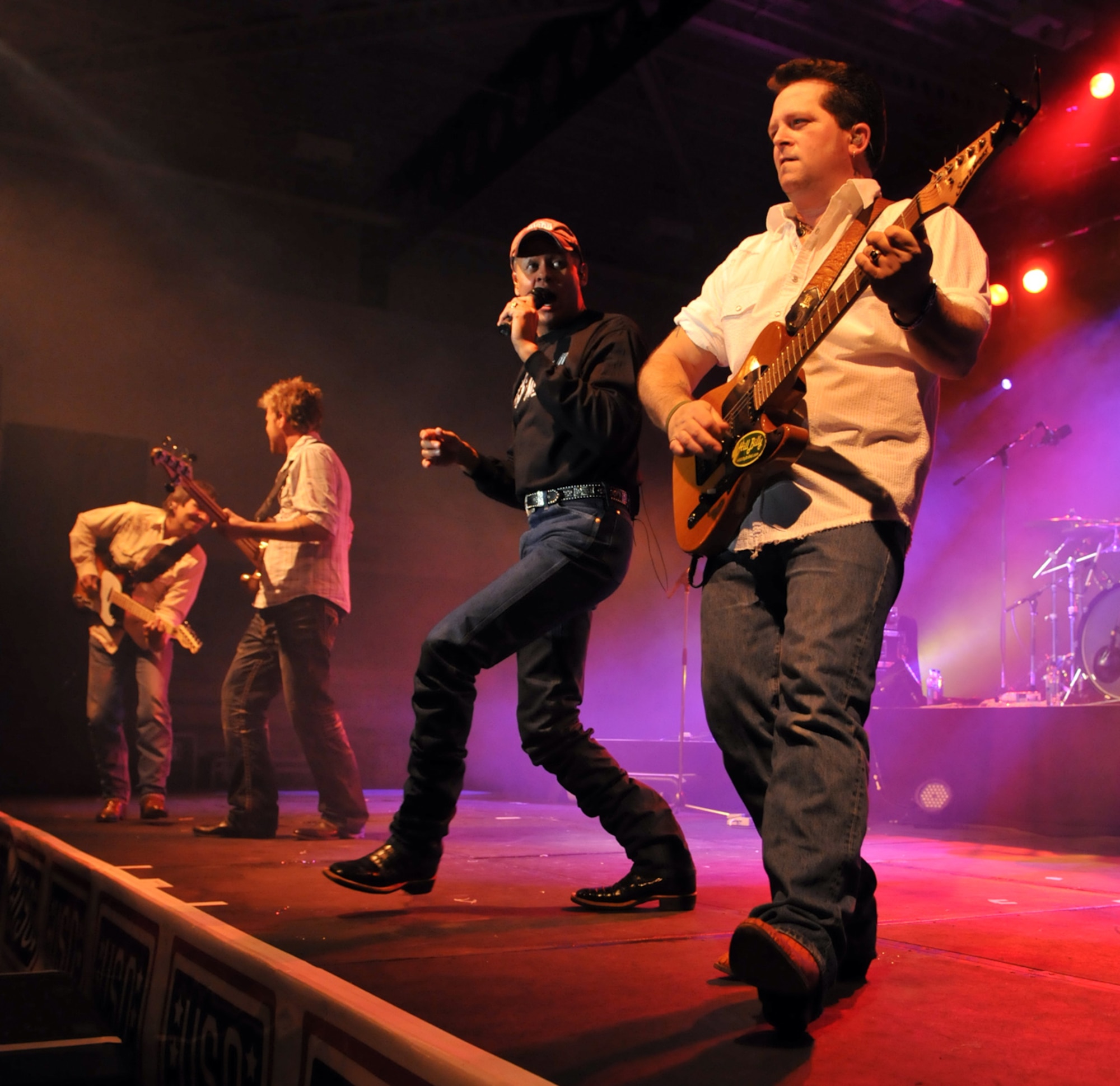RAF MILDENHALL, England – Country singer Neal McCoy and members of his band perform for fans during a concert for members of Team Mildenhall Jan. 25.  (U.S. Air Force photo by Staff Sgt. Austin M. May)