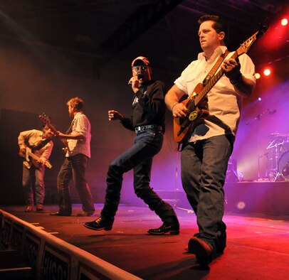 RAF MILDENHALL, England – Country singer Neal McCoy and members of his band perform for fans during a concert for members of Team Mildenhall Jan. 25.  (U.S. Air Force photo by Staff Sgt. Austin M. May)