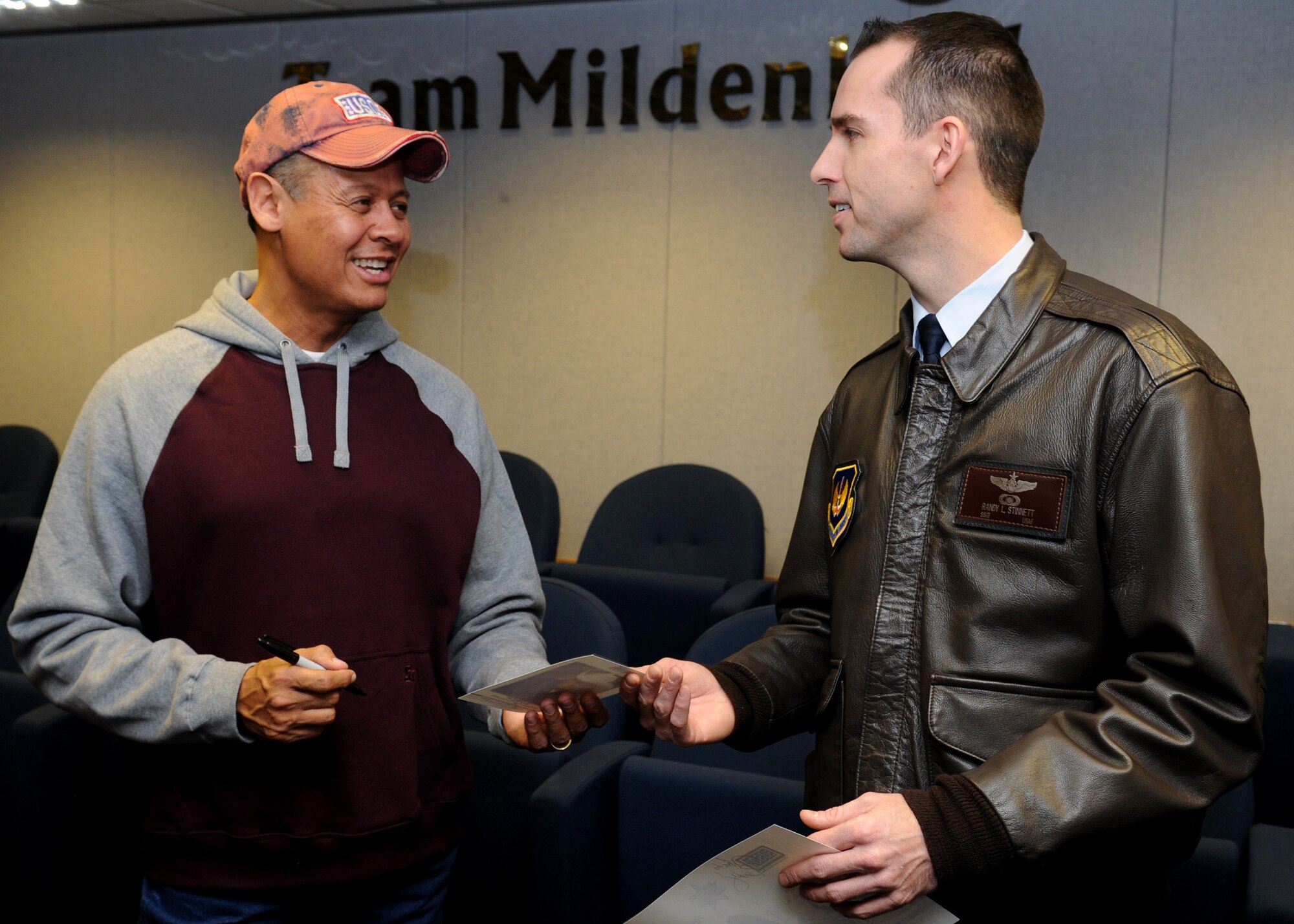RAF MILDENHALL, England – Country singer Neal McCoy, signs an autograph for Staff Sgt. Randy Stinnett, 351st Air Refueling Squadron boom operator, inside the wing headquarters conference room Jan. 25. Mr. McCoy, along with four members of the Dallas Cowboys Cheerleaders met with Mildenhall servicemembers during the United Services Organization European Tour January 2010. (U.S. Air Force photo/ Staff Sgt. Jerry Fleshman)