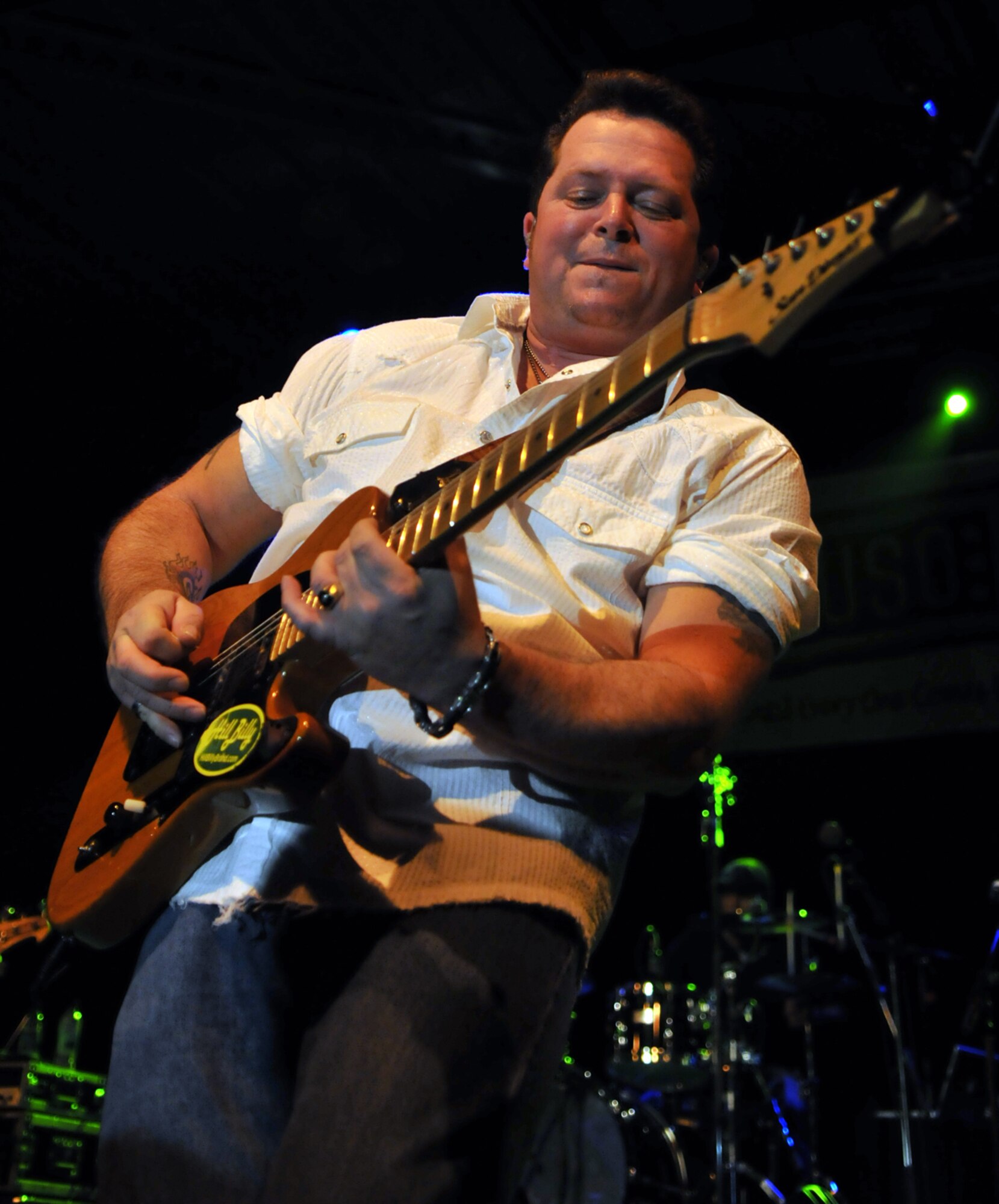 RAF MILDENHALL, England – Daryl Preston, guitarist for country singer Neal McCoy, performs a solo during a concert for servicemembers here Jan. 25.  The musicians performed alongside the Dallas Cowboys Cheerleaders as part of the United Services Organization’s 2010 European tour.  (U.S. Air Force photo by Staff Sgt. Austin M. May)