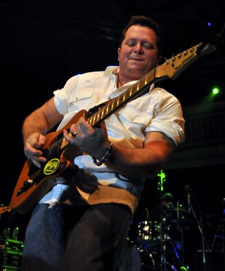 RAF MILDENHALL, England – Daryl Preston, guitarist for country singer Neal McCoy, performs a solo during a concert for servicemembers here Jan. 25.  The musicians performed alongside the Dallas Cowboys Cheerleaders as part of the United Services Organization’s 2010 European tour.  (U.S. Air Force photo by Staff Sgt. Austin M. May)