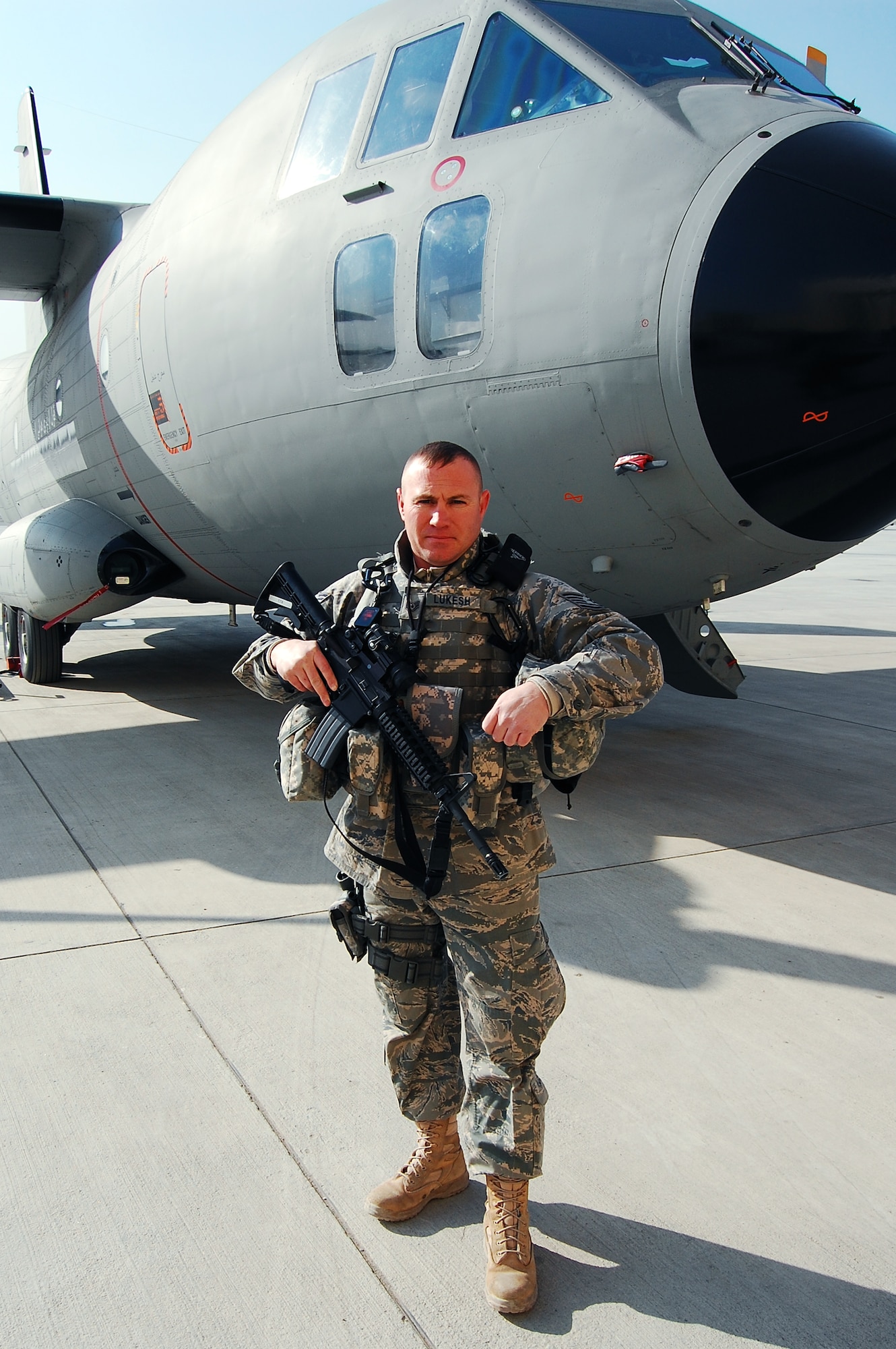 WHITEMAN AIR FORCE BASE, Mo. - Tech. Sgt. Michael Lukesh, 440th Air Expeditionary Advisory Group, stands in front of an Italian-made C-27 Spartan in Kabul, Afghanistan. Deployed from the 509th Maintenance Squadron, Sergeant Lukesh is part of a team responsible for training more than 4,000 Afghanistan National Army Air Corps personnel on proper maintenance and operation of their fleet of aircraft. (Courtesy photo)