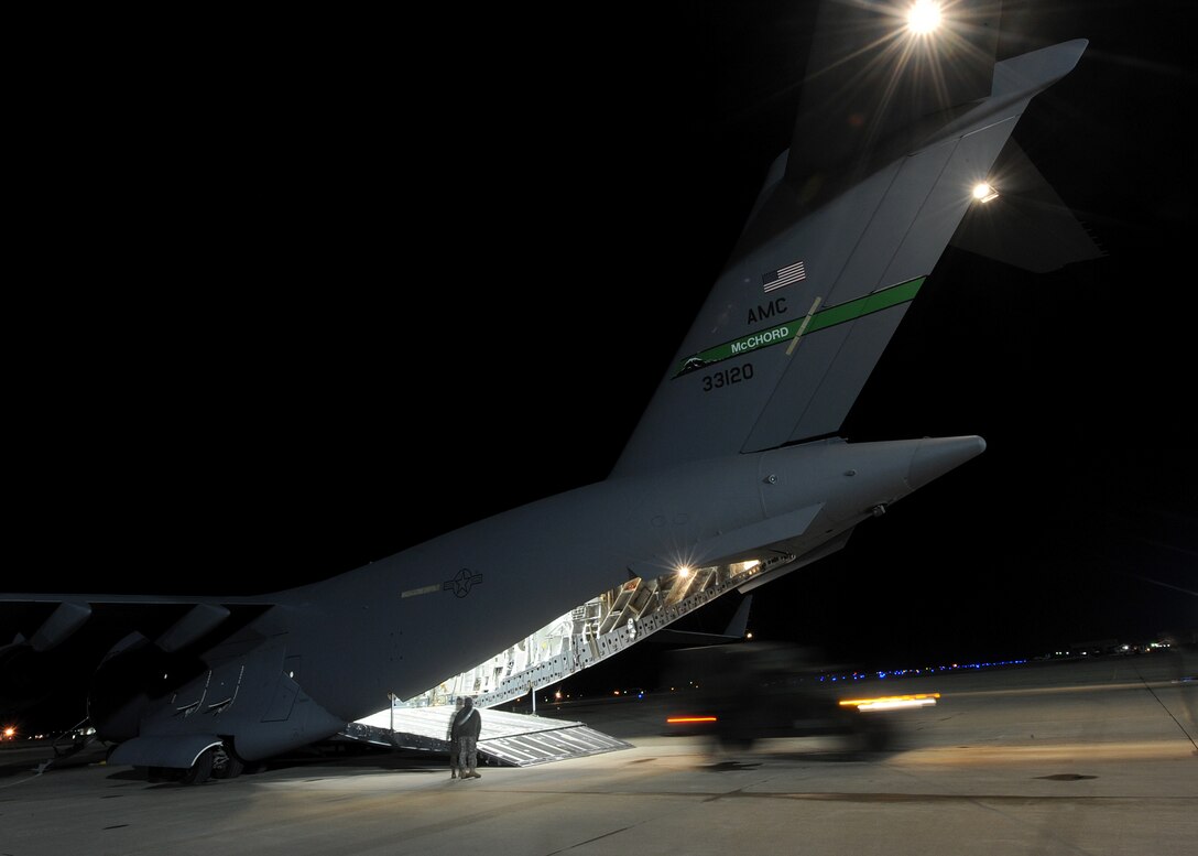 LANGLEY AIR FORCE BASE, Va. – A military multipurpose vehicle backs into the bay of a C-17 Globemaster III Jan. 22 in support Operation Unified Response, a massive movement of military personnel and supplies to aid in relief efforts following the devastating earthquake that struck Haiti on Jan. 12. Langley Airmen and U.S. Army personnel from Fort Eustis loaded the aircraft, the third of its type to transfer Peninsula efforts. (U.S. Air Force photo/ Airman Rebecca Montez)