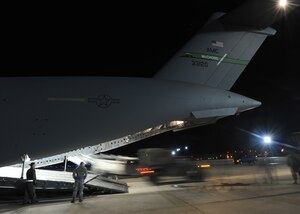 LANGLEY AIR FORCE BASE, Va. – A military multipurpose vehicle backs a high-powered light fixture into the bay of a C-17 Globemaster III Jan. 22 in support Operation Unified Response, a massive movement of military personnel and supplies to aid in relief efforts following the devastating earthquake that struck Haiti on Jan. 12. Langley Airmen and U.S. Army personnel from Fort Eustis loaded the aircraft, the third of its type to transfer Peninsula efforts. (U.S. Air Force photo/ Airman Rebecca Montez)