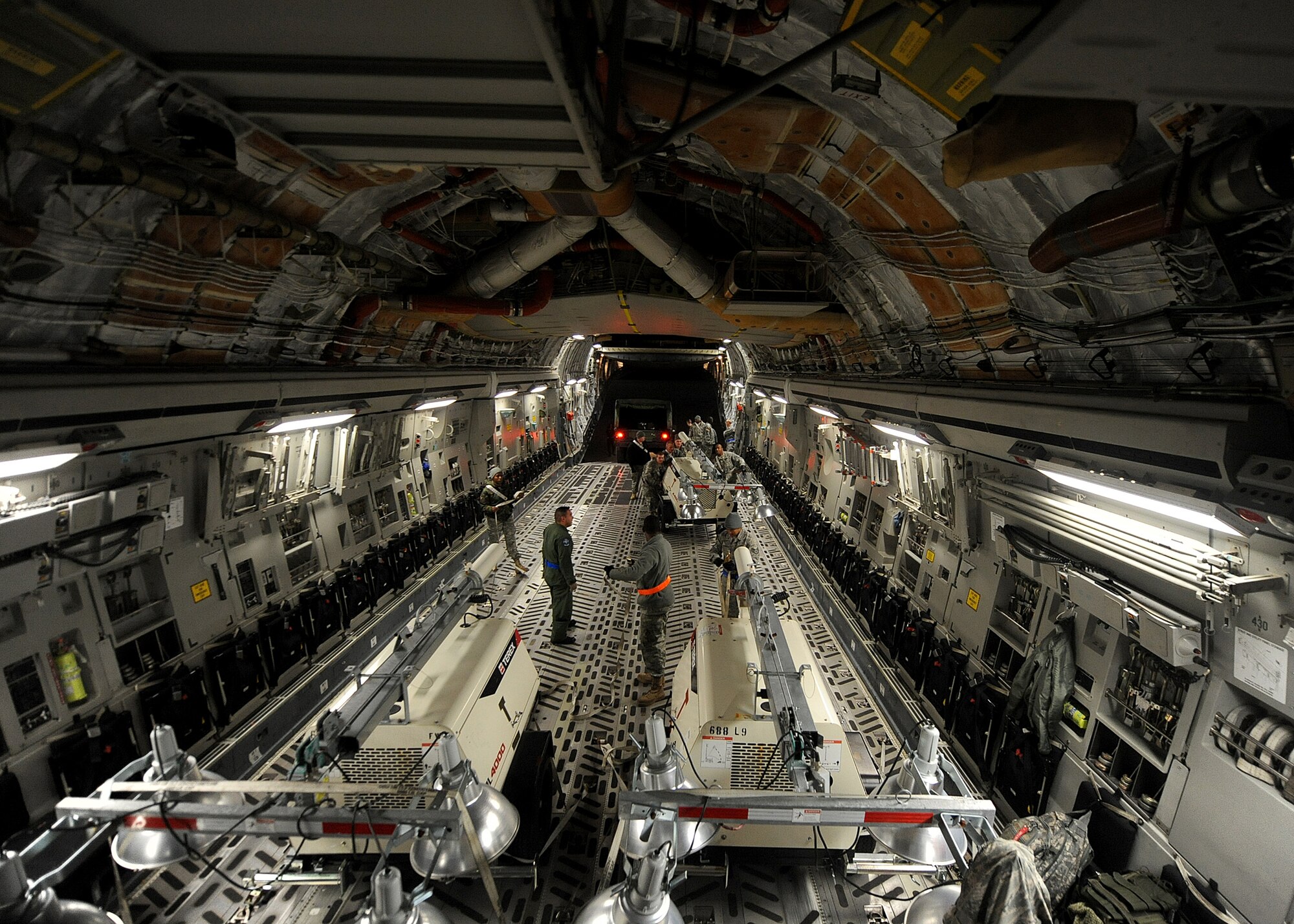 LANGLEY AIR FORCE BASE, Va. – Army and Air Force personnel work together to load supplies into a C-17 Globemaster III Jan. 22 in support Operation Unified Response, a massive movement of military personnel and supplies to aid in relief efforts following the devastating earthquake that struck Haiti on Jan. 12. Langley Airmen and U.S. Army personnel from Fort Eustis loaded the aircraft, the third of its type to transfer Peninsula efforts. (U.S. Air Force photo/ Airman Rebecca Montez)