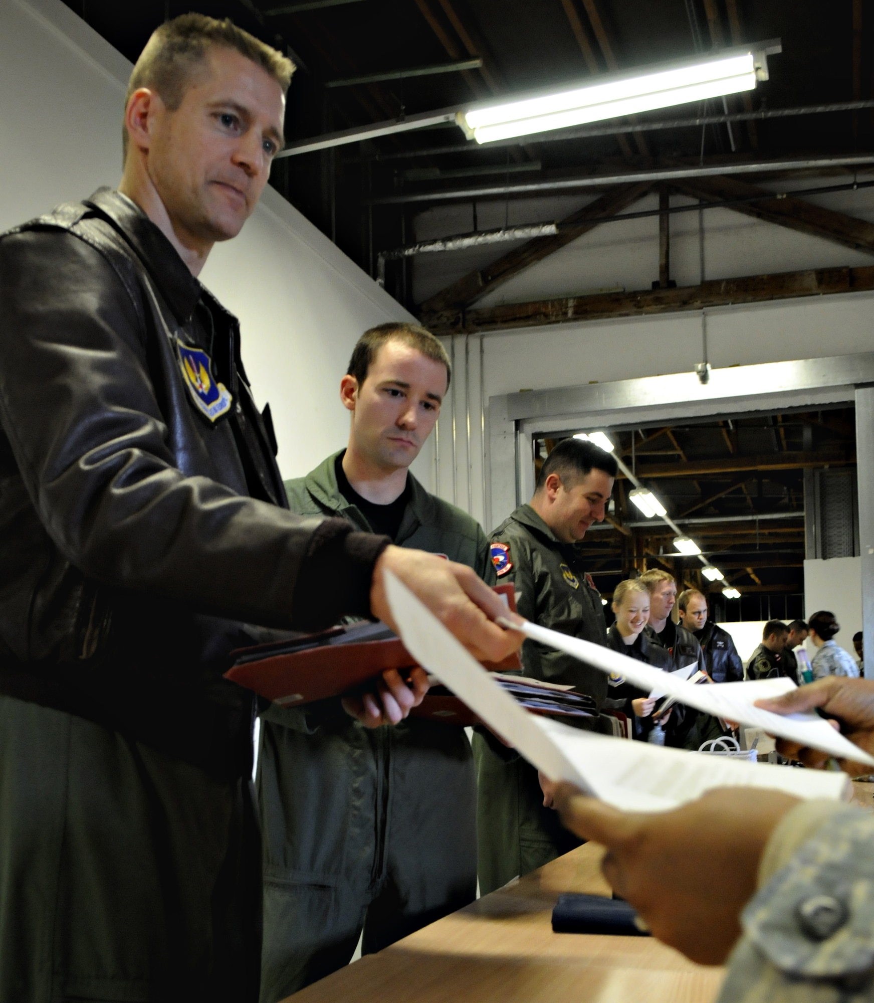 SPANGDAHLEM AIR BASE, Germany – Col. Douglas Nikolai, 22nd Fighter Squadron commander, processes through a personnel deployment function line during Operation Saber Crown 10-03 Jan. 20 in Bldg. 103. The exercise evaluated the wing’s ability to support short-notice deployments and to prepare for the upcoming operational readiness inspections and NATO force evaluation this summer. (U.S. Air Force photo/Airman 1st Class Staci Miller)