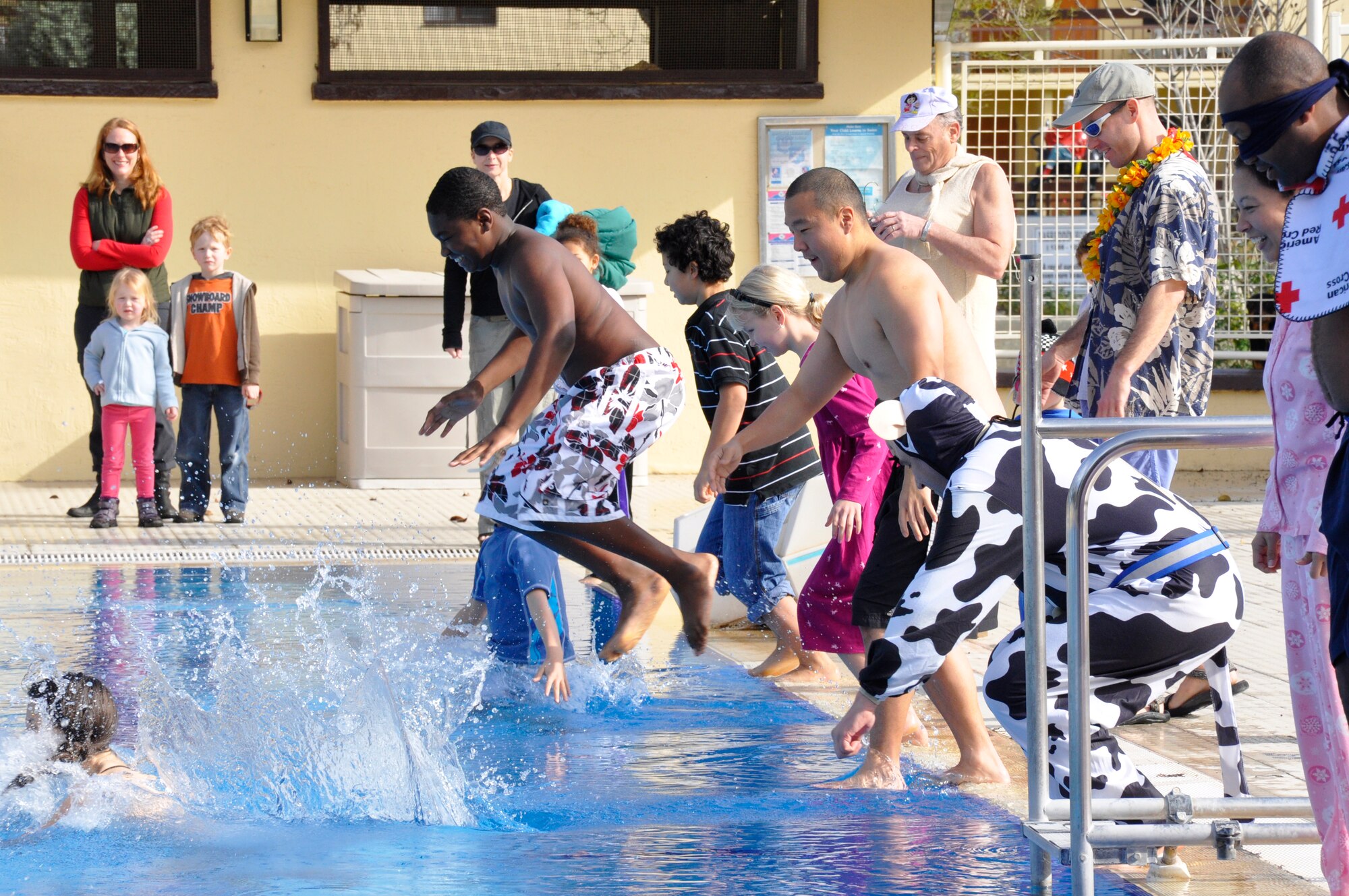 Participants of the Polar Plunge dive into cold water at the base pool Saturday, Jan. 23, 2010 at Incirlik Air Base, Turkey.  The 39th Force Support Squadron sponsored event challenged people to test their bravery and tolerance to cold water.  Participants were encouraged to wear costumes for a chance to win prizes for best costume and best theme.  (Courtesy Photo)