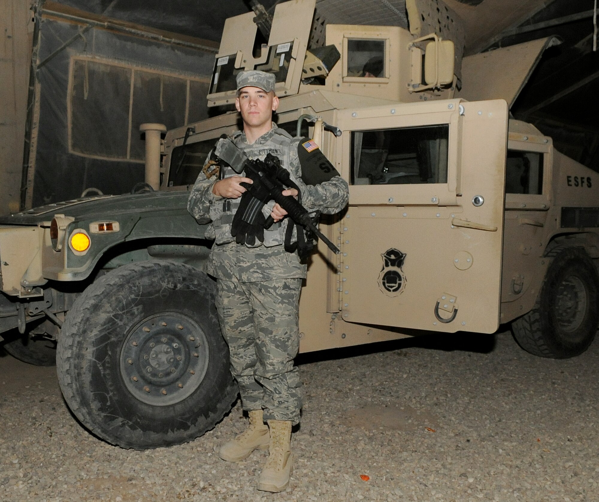 KIRKUK REGIONAL AIR BASE, Iraq – Airman 1st Class Cody Pittman, 506th Expeditionary Security Forces Squadron heavy weapon member, prepares to mount a humvee after attending guard mount Jan. 23, 2010. This is Airman Pittman’s first deployment, and his job is to man the turret and be the eyes and ears for the other members of his patrol team.  He is deployed from the 940th SFS, Beale AFB, Calif. (U.S. Air Force photo/Staff Sgt. Tabitha Kuykendall)