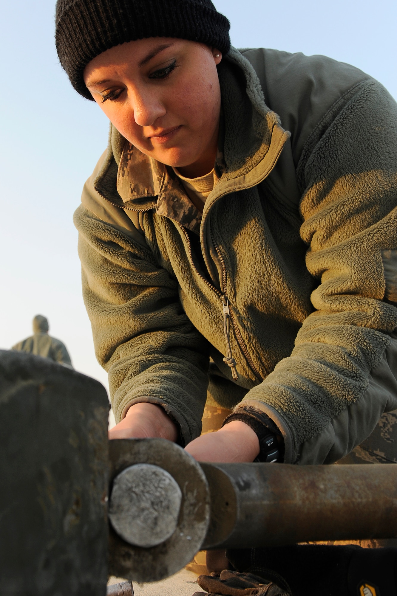 BAGRAM AIRFIELD, Afghanistan--U.S. Air Force Airmen Senior Airman Melissa Gillett, 455th Expeditionary Civil Engineer Squadron, maintains arresting cables at Bagram Airfield, Jan. 15, 2010. Gillett is a member of the Minnesota National Guard from Duluth, Minn. (U.S. Air Force photo by: Tech. Sgt. Jeromy K. Cross)