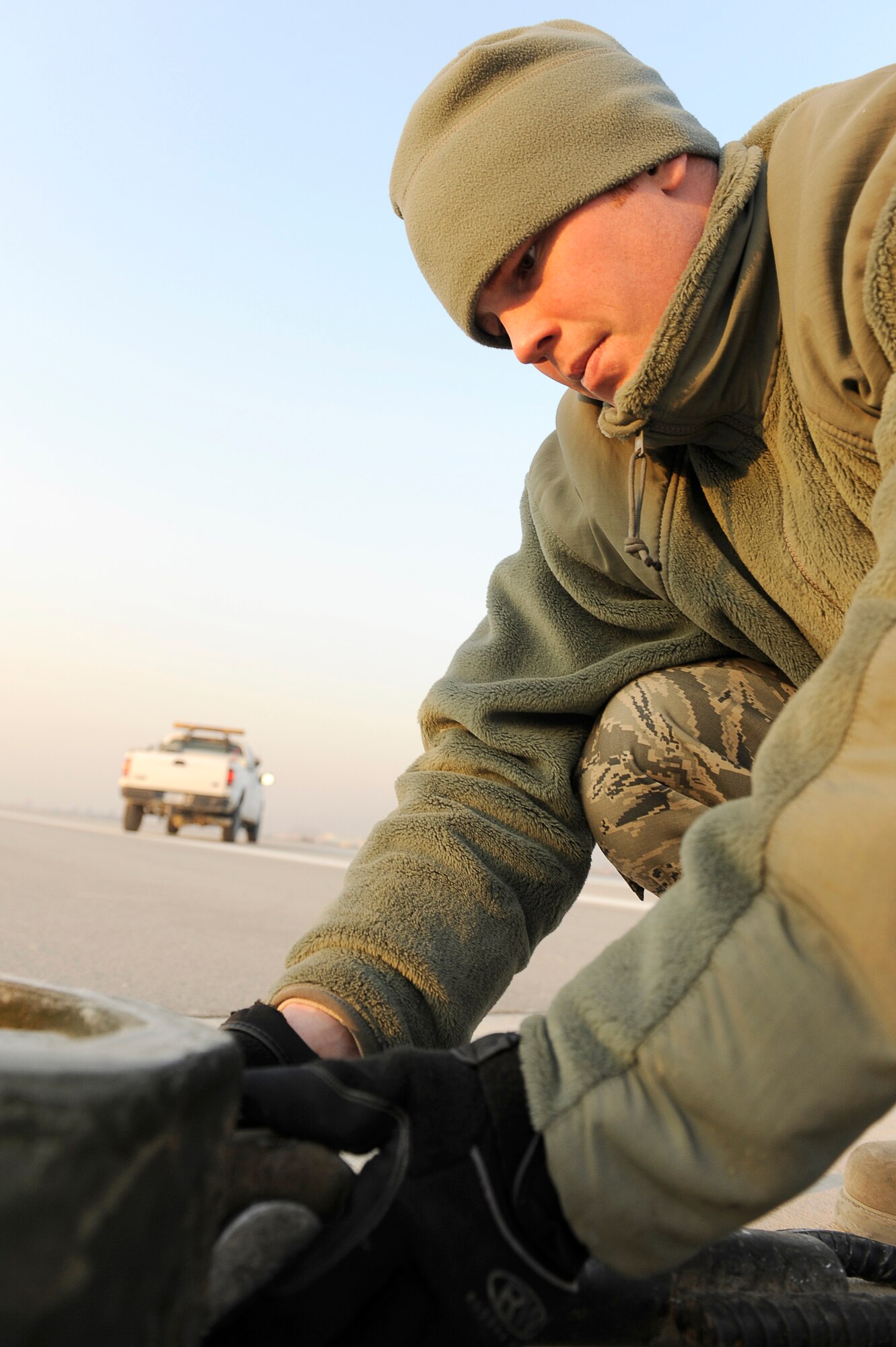 BAGRAM AIRFIELD, Afghanistan--U.S. Air Force Staff Sgt. Eric Austin, 455th Expeditionary Civil Engineer Squadron, maintains an arresting cable at Bagram Airfield, Jan. 15, 2010. Austin is a member of the Minnesota National Guard from Superior, Wis. (U.S. Air Force photo by: Tech. Sgt. Jeromy K. Cross)