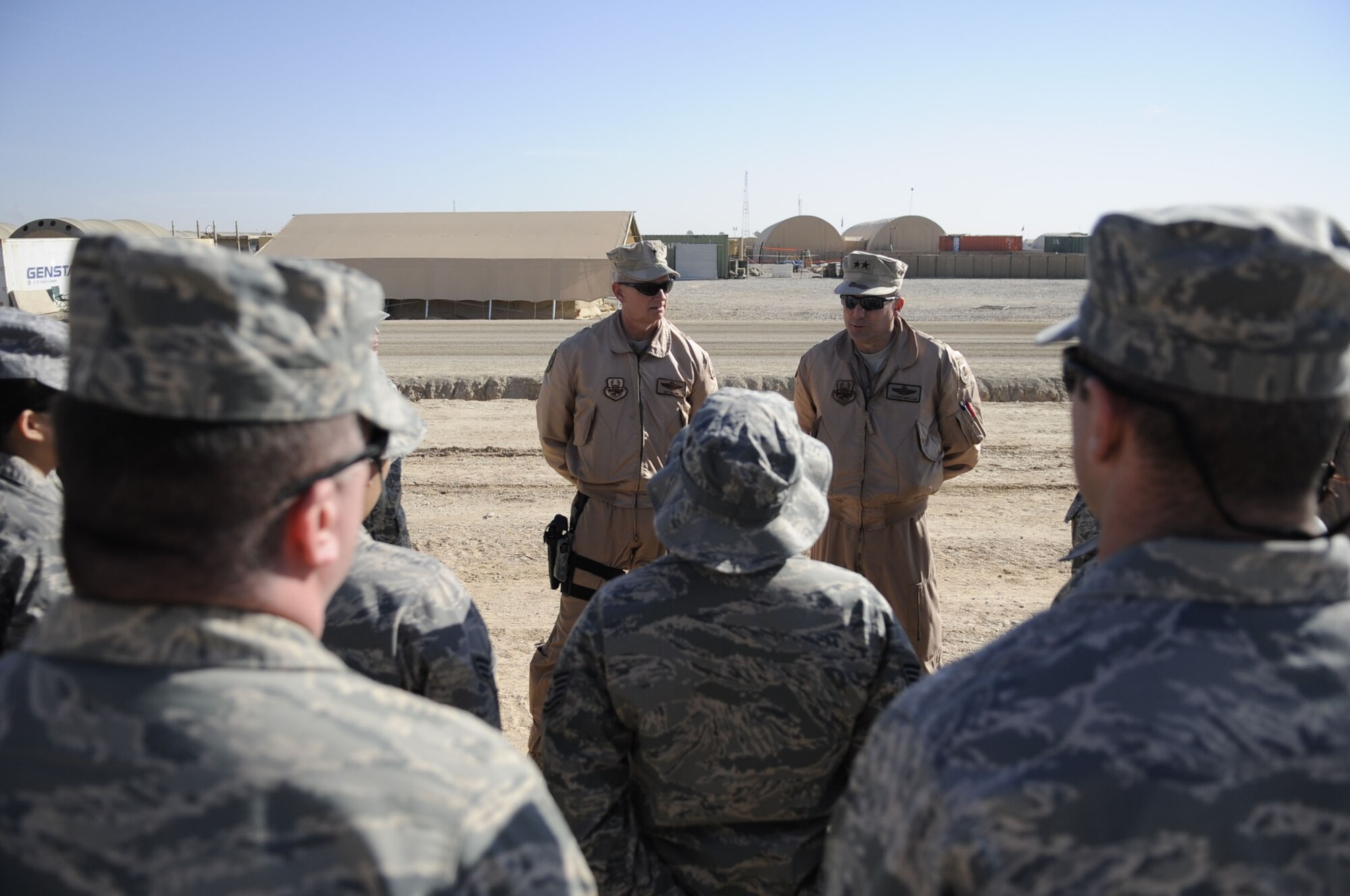 Brig. Gen. Guy Walsh, 451st Air Expeditionary Wing commander, and Maj. Gen. Stephen Mueller, director, Air Component Coordination Element, Air Force Central Command, Kabul, Afghanistan, talk to the new medical staff at Camp Bastion Jan. 19, 2010. The Airmen are preparing to stand up the contingency aeromedical staging facility and the aeromedical evacuation operations team on Camp Bastion in Helmand Province, Afghanistan. (U.S. Air Force photo/Senior Airman Nancy Hooks/Released)
