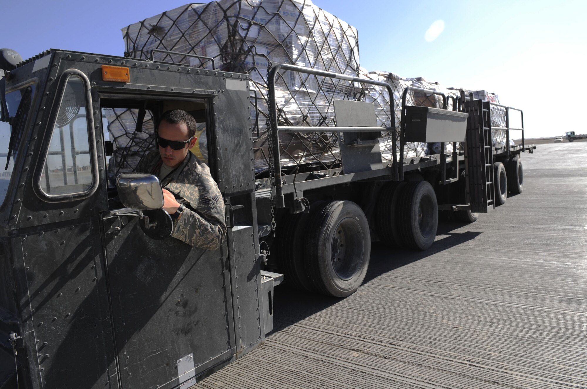 Senior Airman Travis Dupuy, Air Terminal Operation Center ramp controller, reverses in a 60K deck loader with the mail run from a DC8 aircraft at Camp Bastion, Jan. 20, 2010.  ATOC is responsible for downloading the aircraft and turning over the cargo to the Army Material Control Team at Camp Bastion.  Airman Dupuy is from the 3rd Aerial Port Squadron, Pope AFB, N.C.  (U.S. Air Force photo/Senior Airman Nancy Hooks/Released)