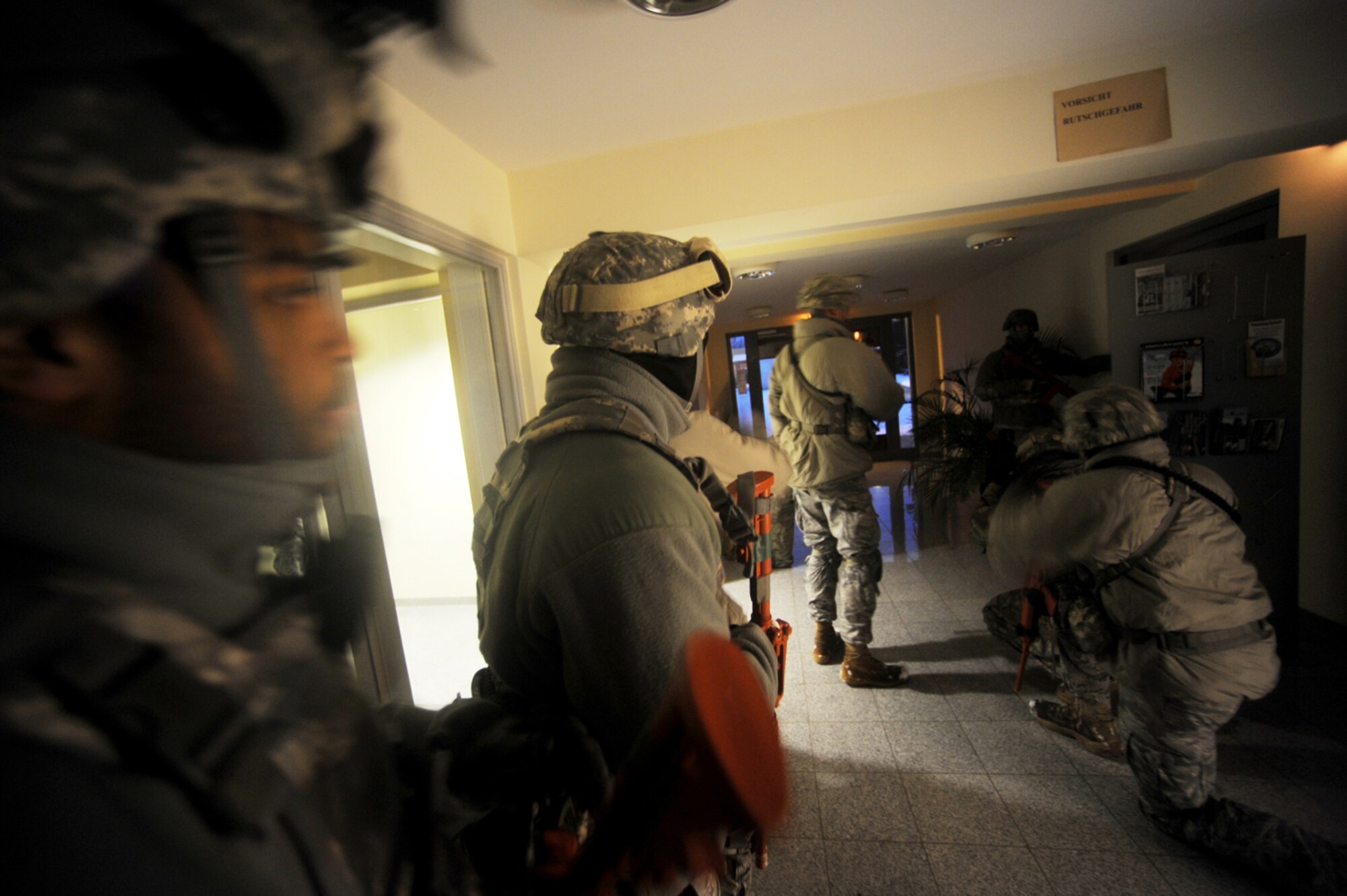 U.S. Air Force members from the 435th Security Forces Squadron, Sembach Annex, Germany, secure a building after an airborne insertion mission, Flugplatz Bitburg, Germany, Jan. 25, 2010, in preparation of Ramstein?s operational readiness inspection in September. The unit is setting up bare-base operations as part of the dual-wing operational readiness exercise with the 86th Airlift Wing. This is the second of five operational readiness exercises. (U.S. Air Force photo by Staff Sgt. Sarayuth Pinthong)