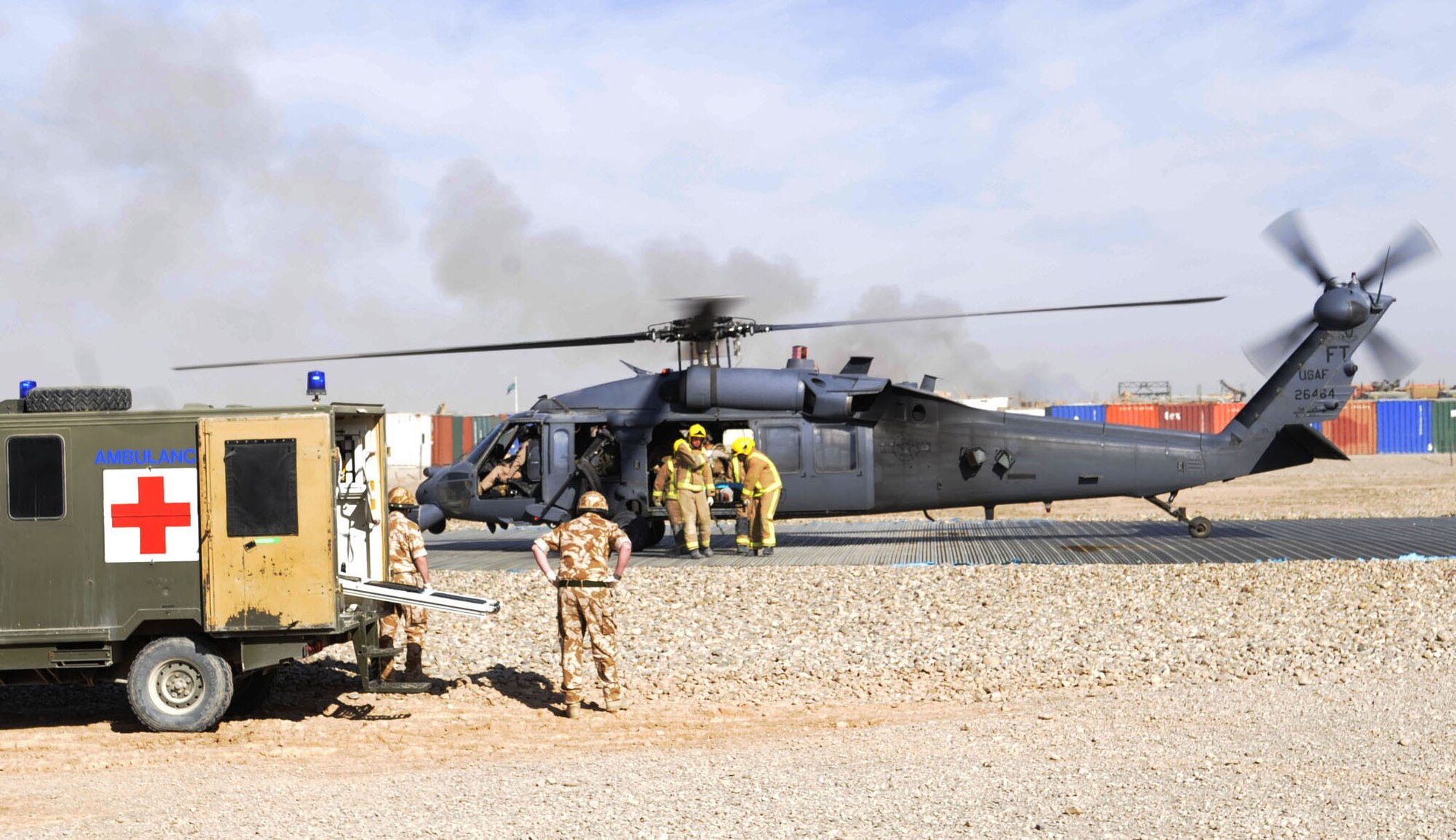 Members from the 66th Expeditionary Rescue Squadron from Camp Bastion, deliver a wounded patient in an HH-60G Pave Hawk helicopter to British Army medics from the Role III hospital on Camp Bastion, Jan. 20, 2010.  The Role III hospital provides emergency care to Afghan nationals and servicemembers serving in Afghanistan. Approximately 600 casualties come through the field hospital each month. A contingency aeromedical staging facility and aeromedical evacuation operations team are scheduled to be stood up by Feb. 1, poised for an additional increase of patients as additional troops deploy to the region. (U.S. Air Force photo/Senior Airman Nancy Hooks/Released)