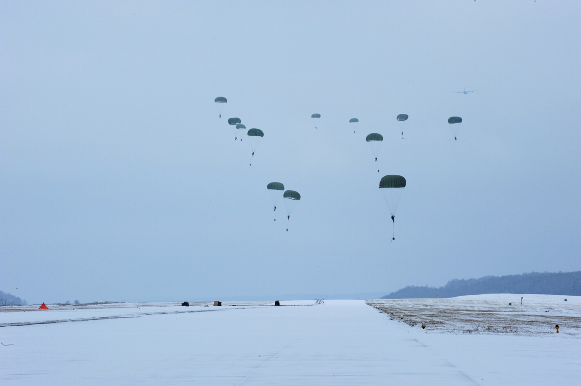 U.S. Air Force members from the 435th Air Ground Operations Wing, Ramstein Air Base, Germany, conduct an airborne insertion mission, Flugplatz Bitburg, Germany, Jan. 25, 2010, in preparation of Ramstein's operational readiness inspection in September. The unit is setting up bare-base operations as part of the dual-wing operational readiness exercise with the 86th Airlift Wing. This is the second of five operational readiness exercises. (U.S. Air Force photo by Staff Sgt. Sarayuth Pinthong)