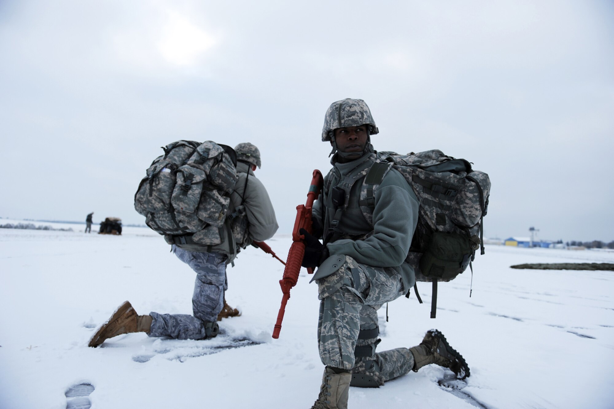 U.S. Air Force Capt. Mark Breed, 435th Security Forces Squadron (SFS), operations officer, and Master Sgt. Tyrone Morgan, 435th SFS, operations superintendent, Sembach Annex, Germany, secures a drop-zone during an insertion mission, Flugplatz Bitburg, Germany, Jan. 25, 2010, in preparation of Ramstein's operational readiness inspection in September. The unit is setting up bare-base operations as part of the dual-wing operational readiness exercise with the 86th Airlift Wing. This is the second of five operational readiness exercises. (U.S. Air Force photo by Staff Sgt. Sarayuth Pinthong)