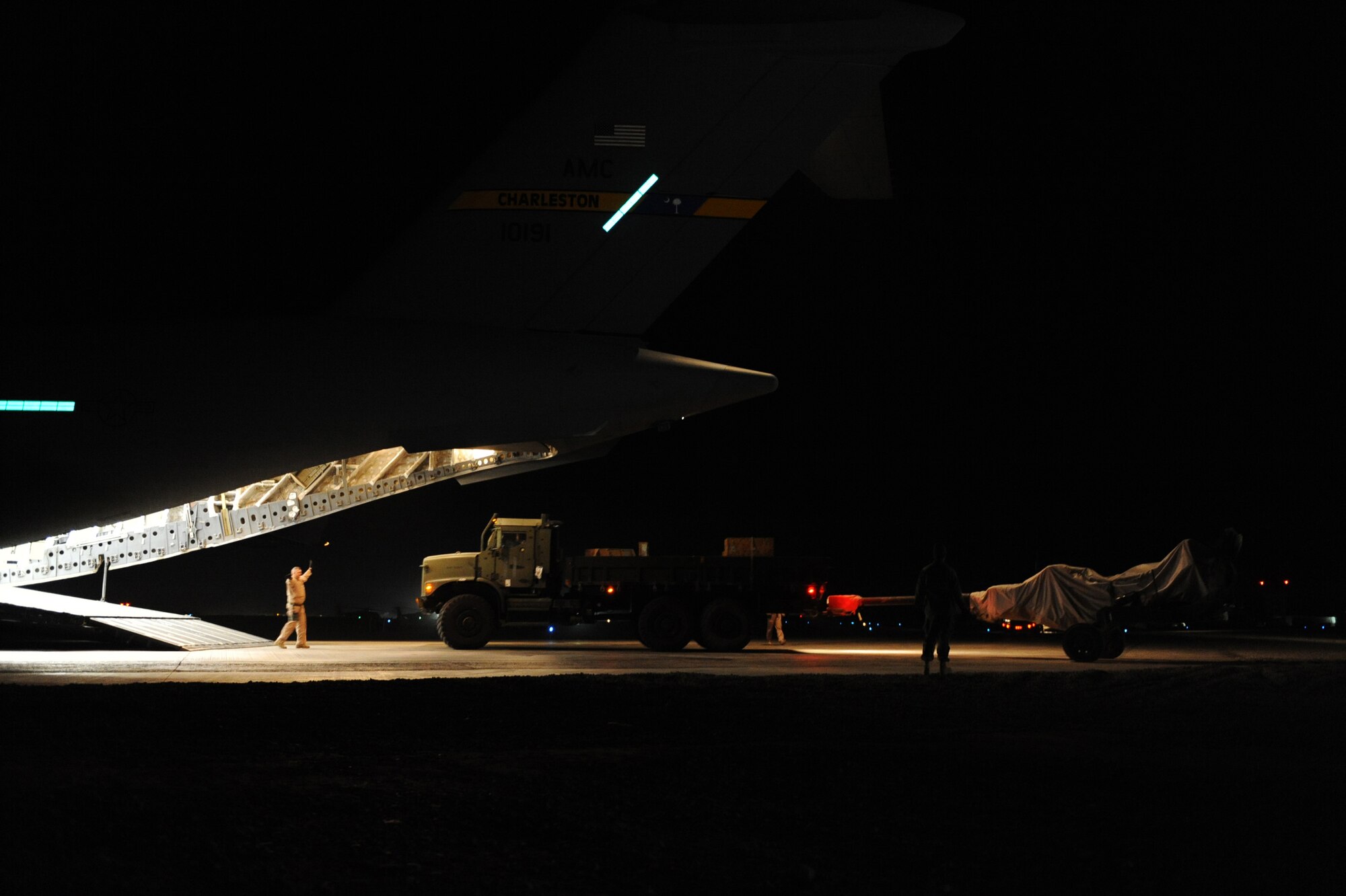 A C-17A Globemaster III aircrew unloads 95,000 pounds of cargo at Camp Bastion, Afghanistan, Jan. 20, 2010. The aircrew is assigned to the 816th Expeditionary Airlift Squadron. (U.S. Air Force photo/Staff Sgt. Manuel J. Martinez)