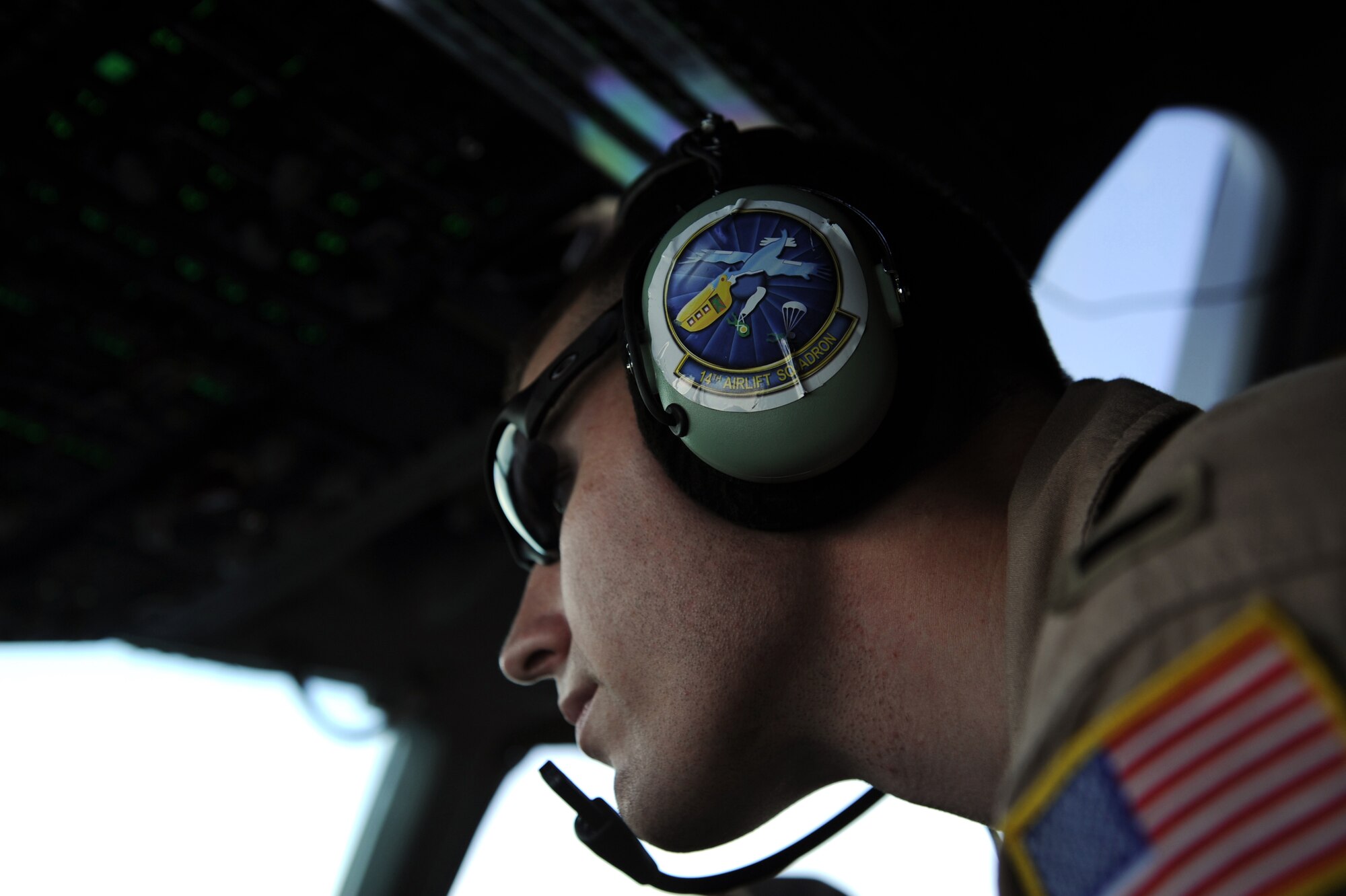 First Lt. Austin S. Tally, a C-17A Globemaster III pilot assigned to the 816th Expeditionary Airlift Squadron, scans the horizon during a transport mission to Afghanistan, Jan. 20, 2010.  (U.S. Air Force photo/Staff Sgt. Manuel J. Martinez)