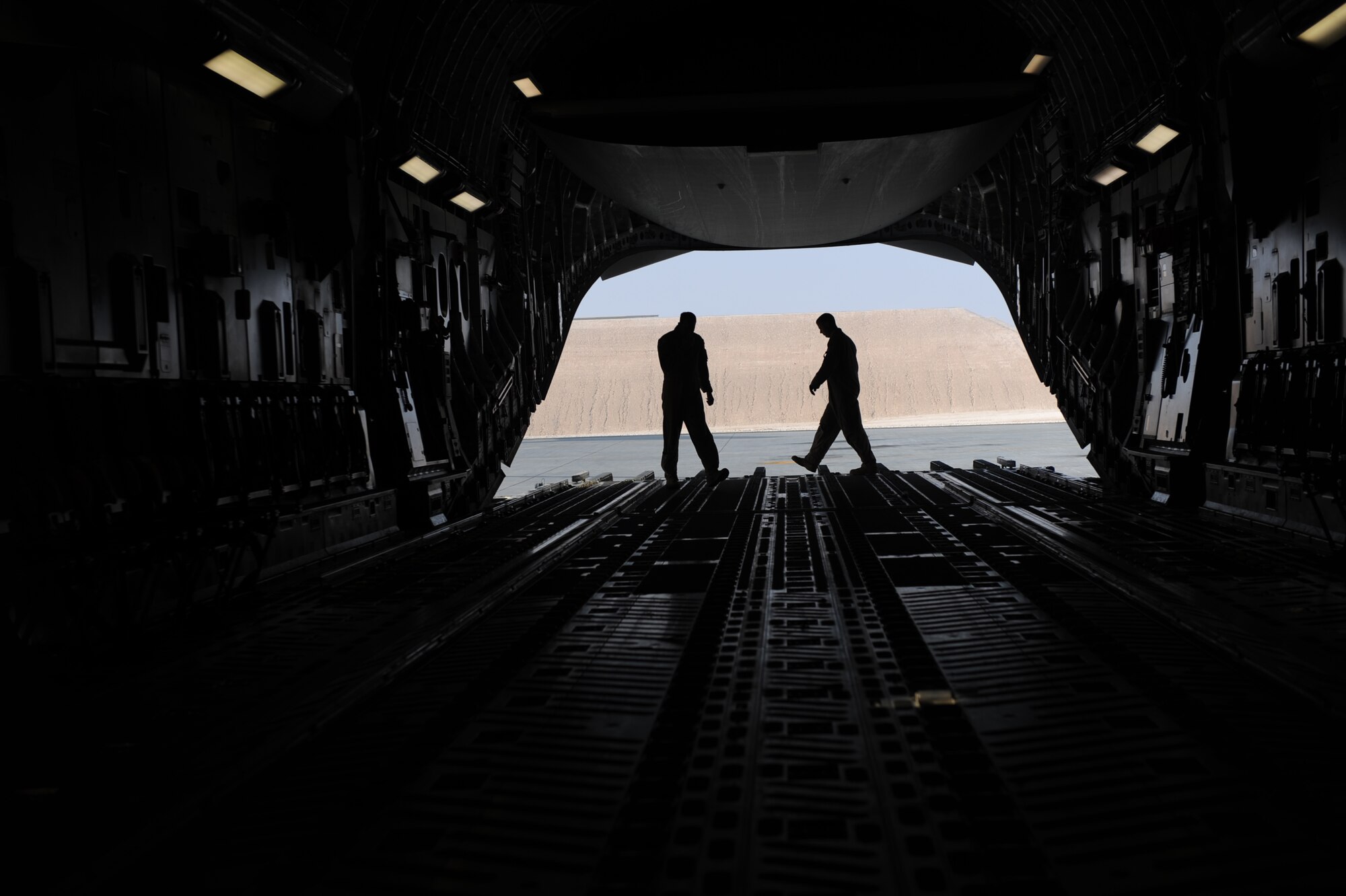 Tech. Sgt. Kevin M. Owens and Senior Airman Anthony E. Fuller, both C-17A Globemaster III loadmasters assigned to the 816th Expeditionary Airlift Squadron, go through prefight checks on the ramp prior to loading cargo for an airlift mision Jan. 20, 2010, at a forward operating base in Southwest Asia. (U.S. Air Force photo/Staff Sgt. Manuel J. Martinez)