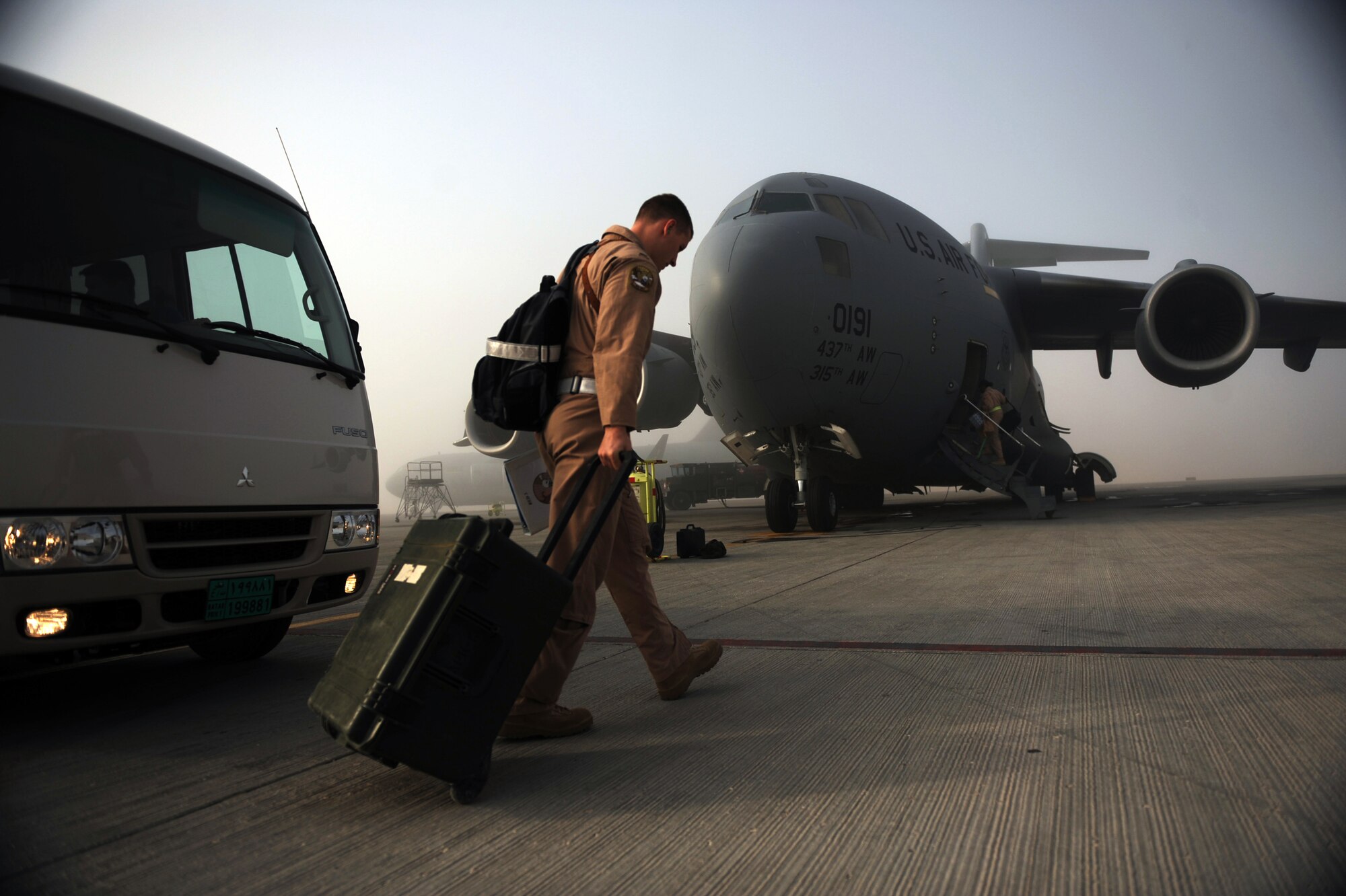 1st Lt. Austin S. Tally, a C-17A Globemaster III pilot assigned to the 816th Expeditionary Airlift Squadron, heads toward his aircraft prior to a cargo-transportation mission Jan. 20, 2010, at a forward operating base in Southwest Asia. (U.S. Air Force photo/Staff Sgt. Manuel J. Martinez)