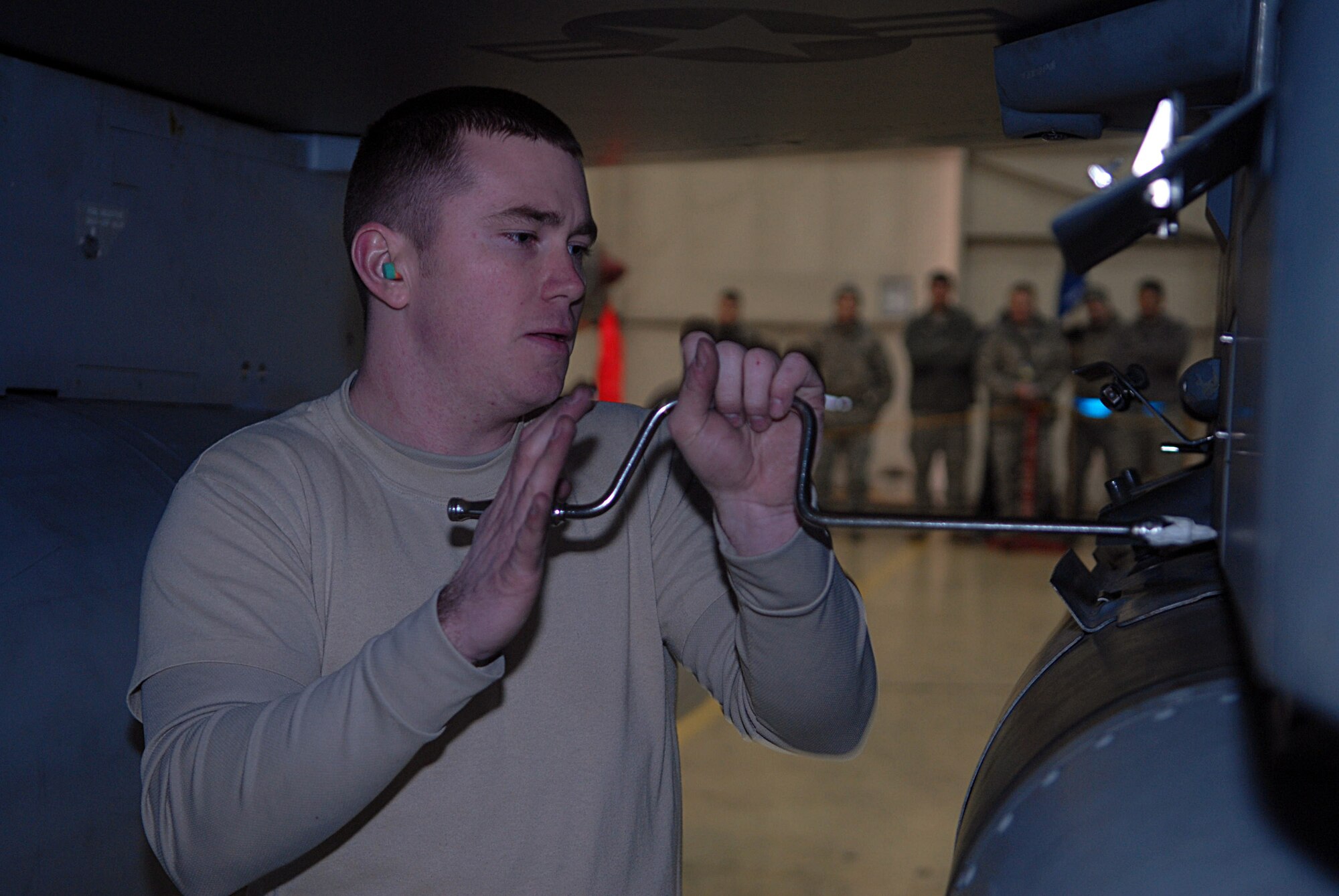KUNSAN AIR BASE, Republic of Korea -- Senior Airman Jesse Tannehill, 8th Aircraft Maintenance Squadron weapons load crew member, secures ammunition on an F-16 Fighting Falcon during a weapons load competition Jan. 22. A weapons load competition is held every month and consist of a three Airmen team. (U.S. Air Force photo/Senior Airman Roy Lynch)