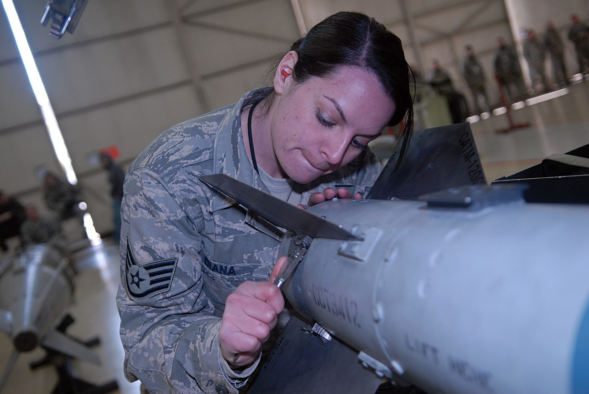 KUNSAN AIR BASE, Republic of Korea -- Staff Sgt. Jennifer Diana, 8th Aircraft Maintenance Squadron weapons load crew member, preps a munitions for an F-16 Fighting Falcon during a weapons load competition Jan. 22. A weapons load competition consists of a three man team to maintain proficiency in weapon loading. (U.S. Air Force photo/Senior Airman Roy Lynch)