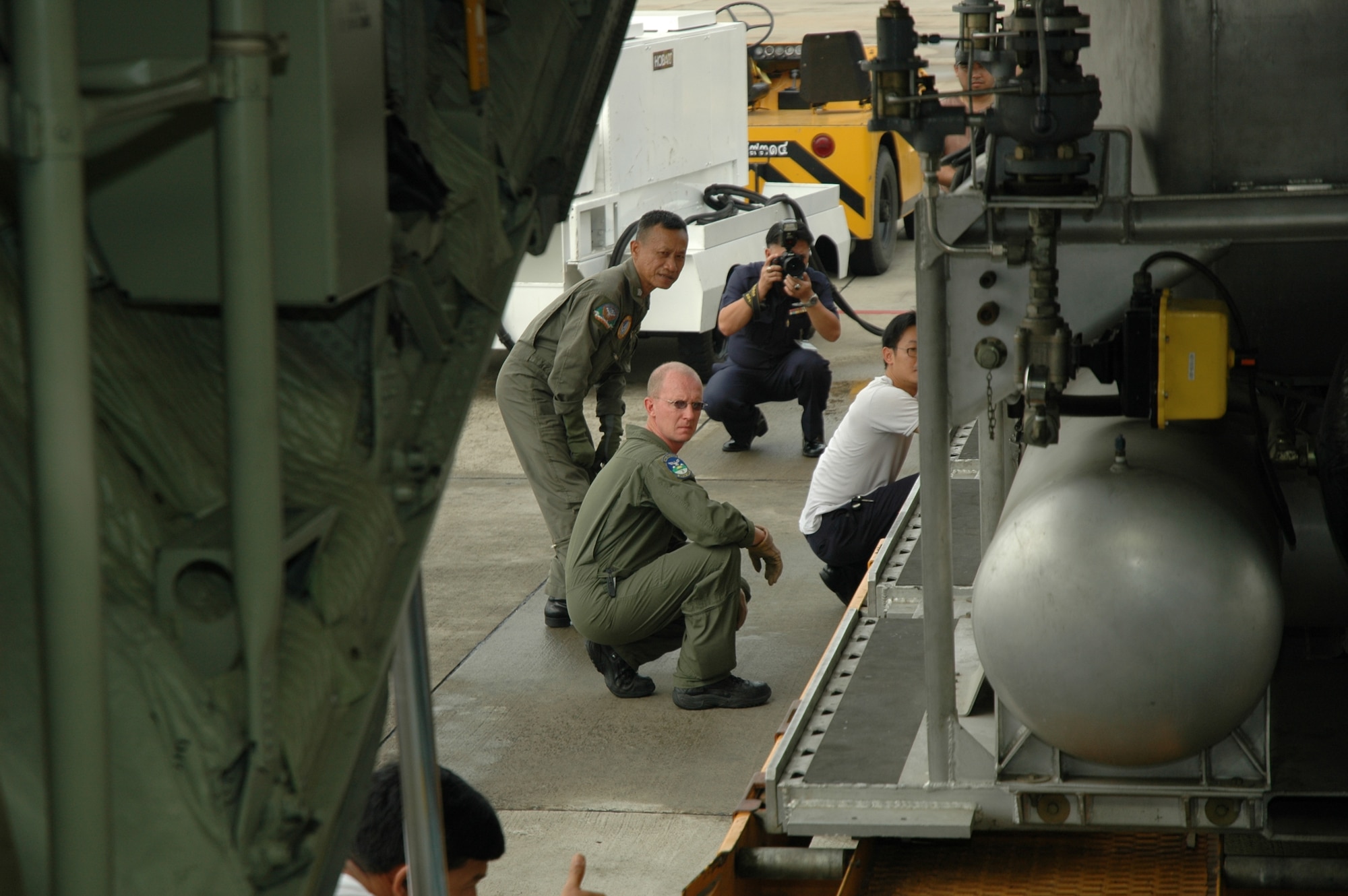 Master Sgt. Tom T. Freeman, loadmaster with the Air Force Reserve’s 302nd Airlift Wing based at Peterson AFB, Colo., help Royal Thai Air Force members load the Modular Airborne Firefighting System at Don Muang Royal Thai Air Force Base, Thailand.  The MAFFS system was transported from Don Muang RTAFB to Phitsanulok RTAFB for MAFFS flying training.  Seven members of the 302 AW traveled to Thailand to provide expert training to RTAF members on safe and effective Modular Airborne Firefighting System operations.  This event marks the first time the Air Force Reserve has sent delegates to train a foreign Air Force on use of the MAFFS equipment. (U.S. Air Force photo/Capt. Jody L. Ritchie)