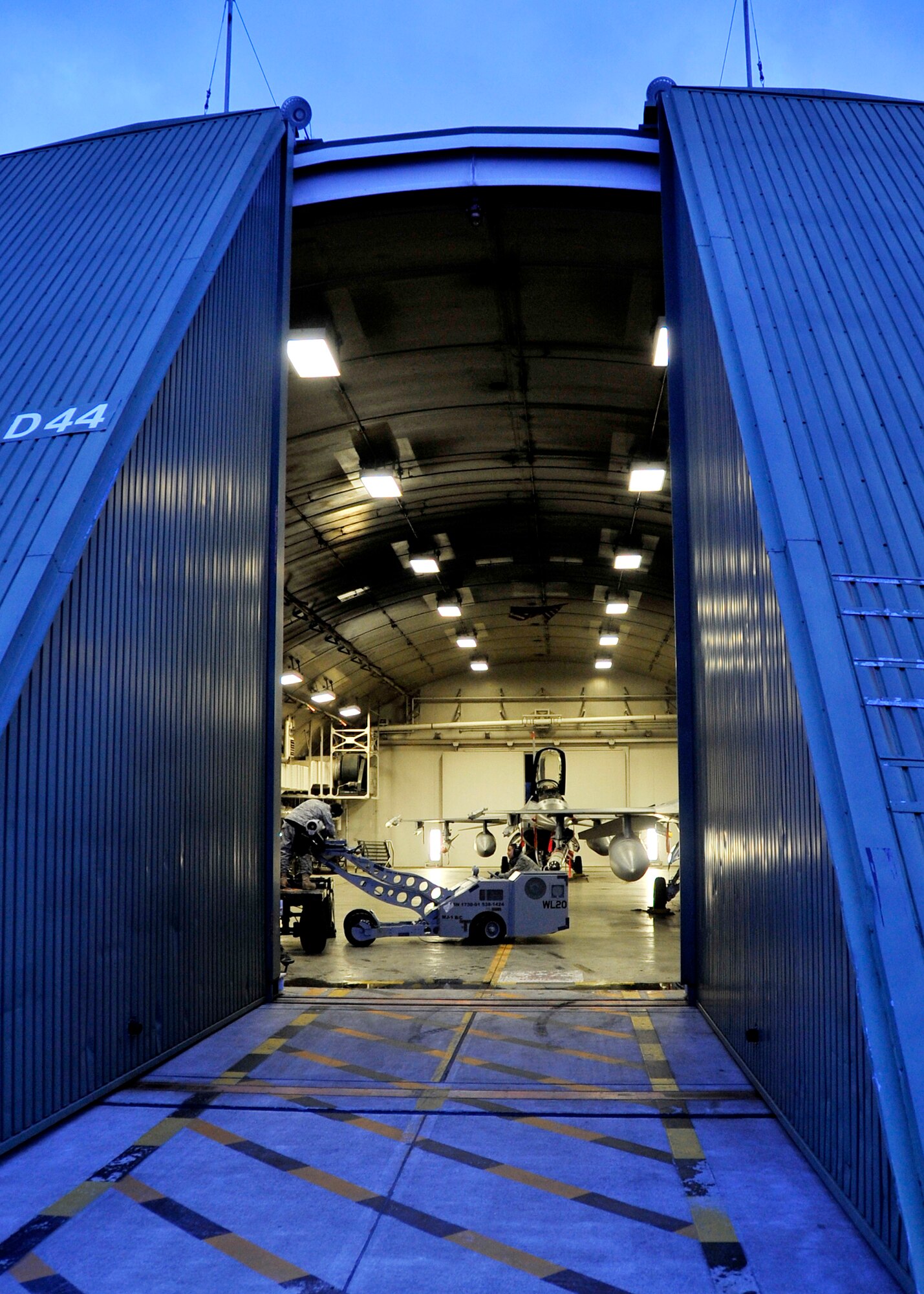 MISAWA AIR BASE, Japan -- Airman 1st Class Aaron Alberto and Staff Sgt. Bradly Smith, 35th Aircraft Maintenance Unit weapons loadcrew members, load munitions on an F-16 Fighting Falcon Jan. 27 during exercise Beverly Sunrise 10-01. Exercises help sharpen necessary skills to operate in emergency situations. (U.S. Air Force Photo/Staff Sgt. Chad C. Strohmeyer)