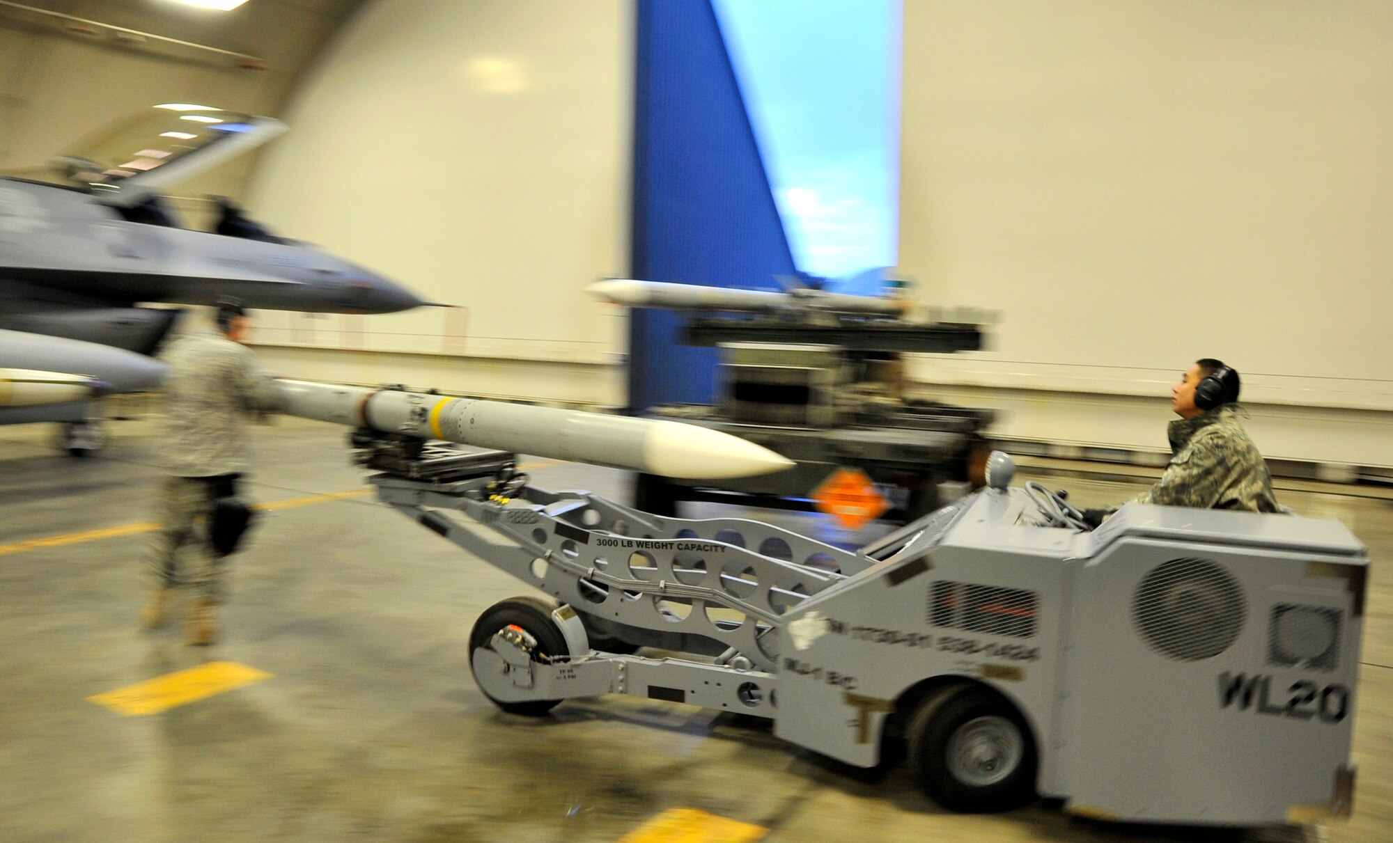 MISAWA AIR BASE, Japan -- Airman 1st Class Aaron Alberto, 35th Aircraft Maintenance Unit weapons loadcrew member, assists in loading munitions using an MJ-1 lift truck Jan. 27 during exercise Beverly Sunrise 10-01. The MJ-1, also called a "jammer," is used to load and unload a wide variety of munitions and has a lifting capacity of 3,000 pounds. (U.S. Air Force Photo/Staff Sgt. Chad C. Strohmeyer)