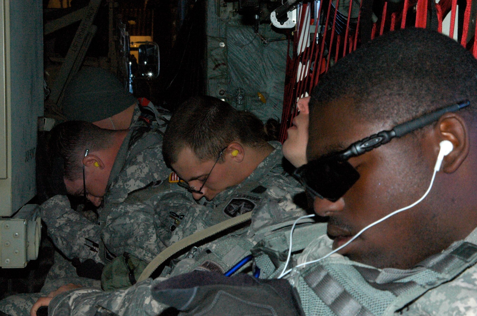 Army Spec. Julian Johnson (right) and other Soldiers from the 82nd Airborne Division get some rest Jan. 27 enroute to Port-au-Prince, Haiti. Specialist Johnson and more than 10 Soldiers in his unit flew on an Air Force Reserve C-130 to Haiti where they deployed in support of earthquake relief operations. Approximately 50 members of the 133rd AW are deployed to Muniz Air Base, Puerto Rico, in support of Air Expeditionary Force Coronet Oak, operated by the 35th Expeditionary Airlift Squadron. (U.S. Air Force photo/Staff Sgt. Stephen J. Collier)