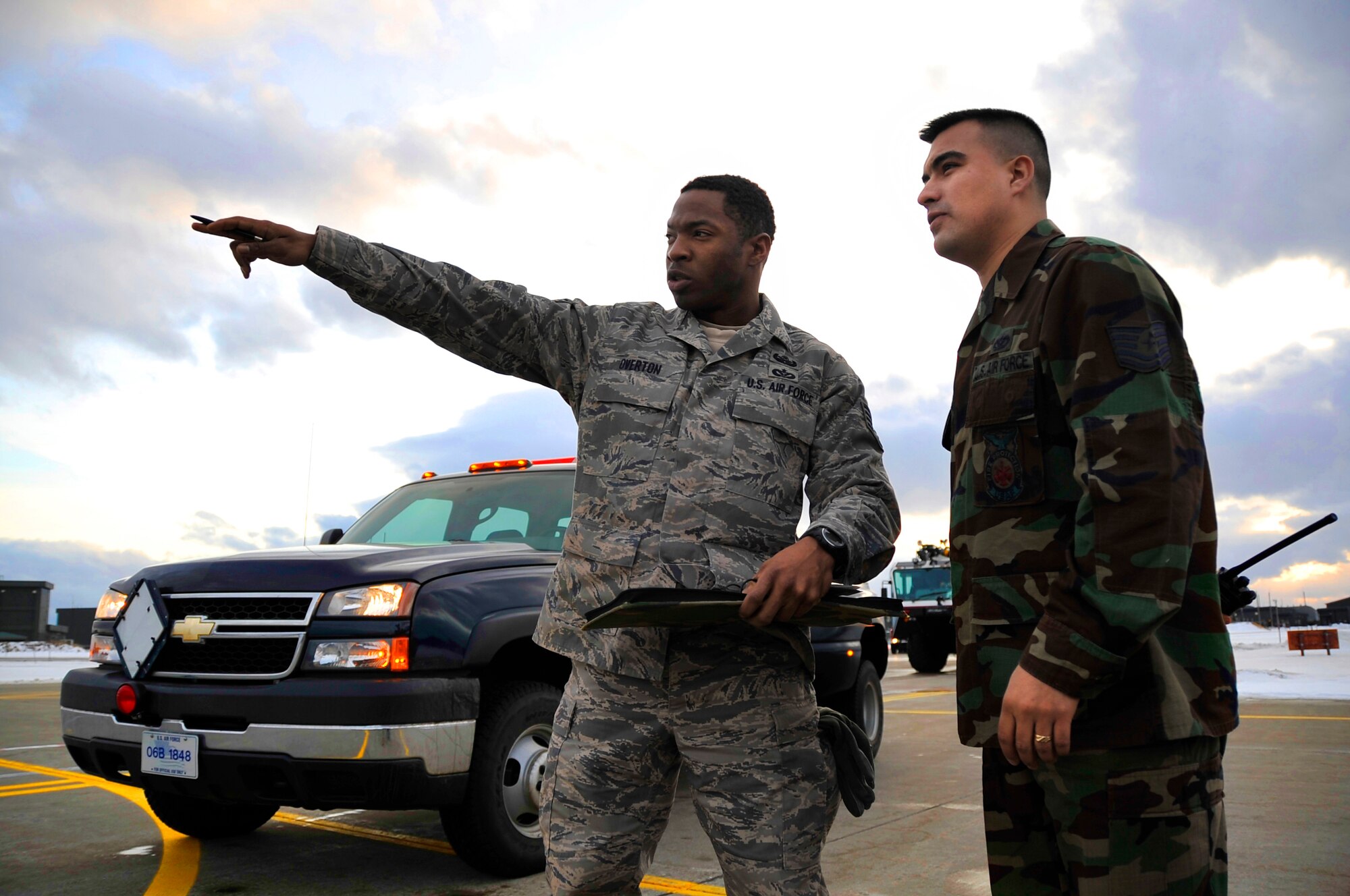 MISAWA AIR BASE, Japan -- Staff Sgt. Michael Overton, 35th Civil Engineer Squadron explosive ordnance disposal technician and Tech. Sgt. Tavio Soto, 35th Civil Engineer Squadron A-shift assistant chief for operations, disucss the correct procedures for a simulated dropped munition Jan. 27 during exercise Beverly Sunrise 10-01. During most dropped munitons scenarios, EOD and the fire department will team up in response. (U.S. Air Force Photo/Staff Sgt. Chad C. Strohmeyer)