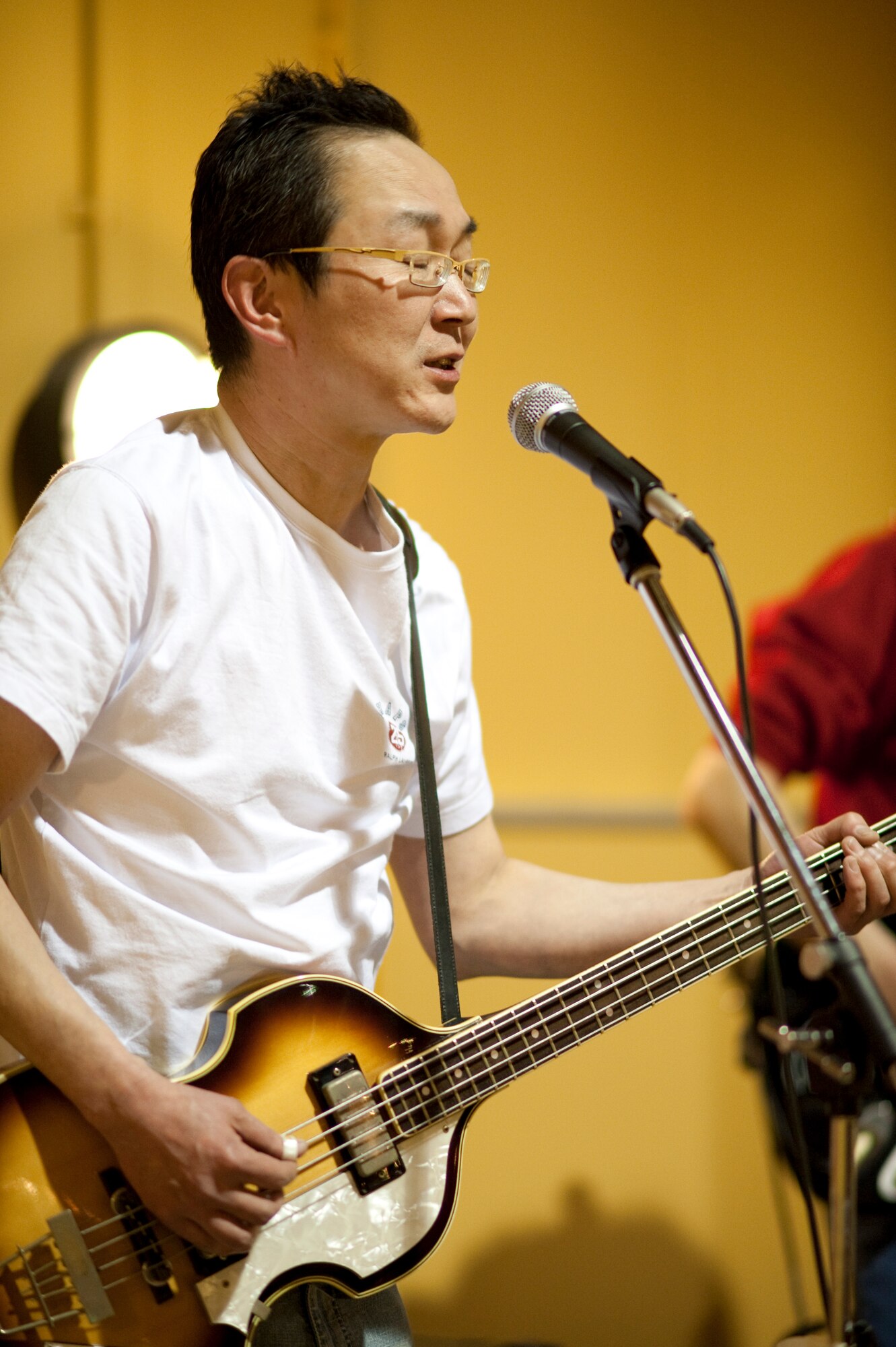 MISAWA AIR BASE, Japan -- Mineo Muto, a local musician, sings and plays an American rock and roll song Jan. 23 at the Airman's Center. Mr. Muto performed as a guest artist with American musicians. (U.S. Air Force photo/Staff Sgt. Samuel Morse)