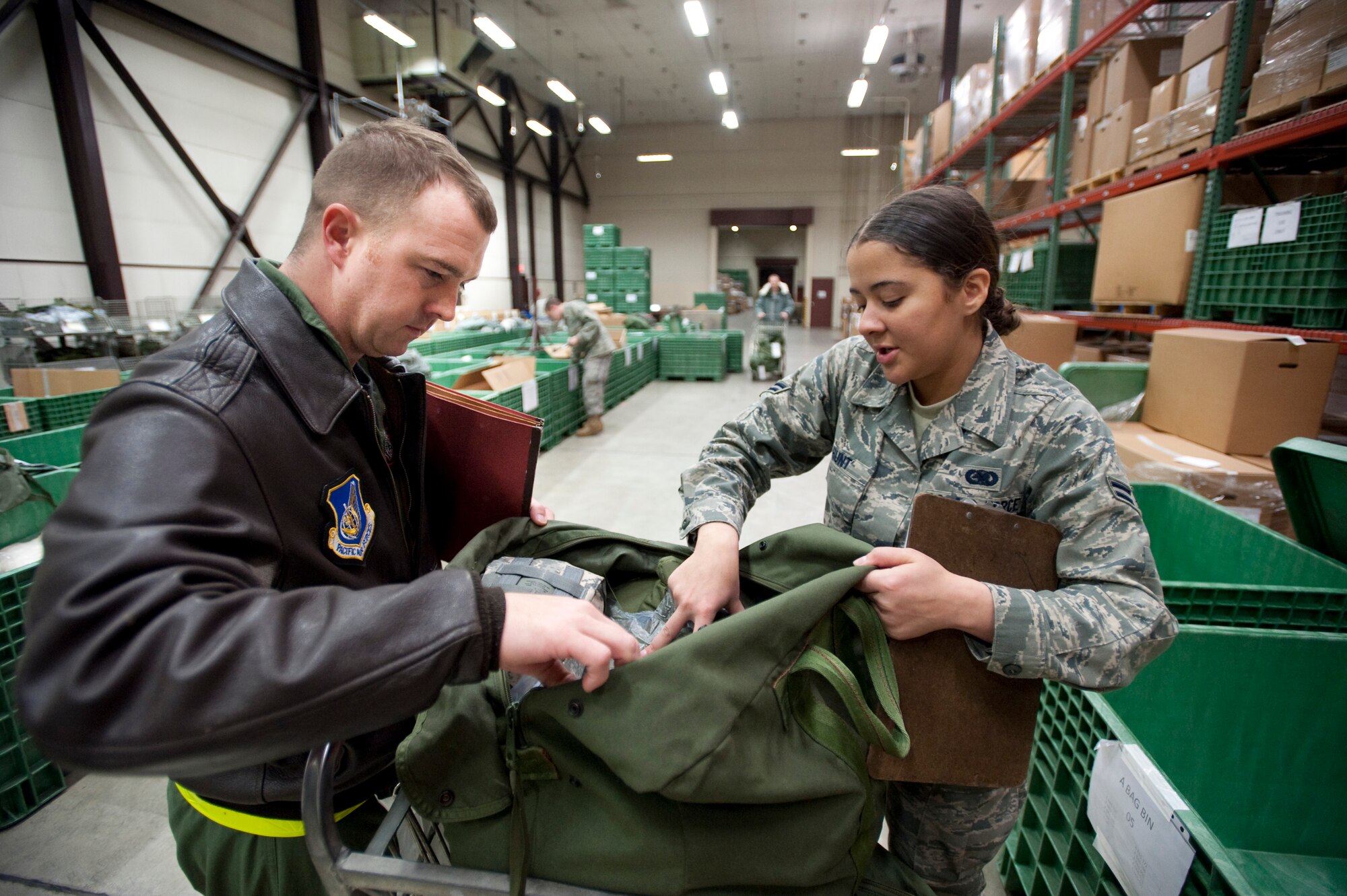 MISAWA AIR BASE, Japan -- Airman 1st Class Tamara Hunt, 35th Logistics Squadron storage and issue, performs an inventory of an equipment bag being issued to Capt. Kyle Wallace, 13th Fighter Squadron pilot, at the 35th Logistics Readiness Squadron supply warehouse Jan. 27. Airman Hunt augmented the 35th LRS individual protective equipment element during the operational readiness exercise to make sure the mock deployers made it to their flight in time. (U.S. Air Force photo/Staff Sgt. Samuel Morse)