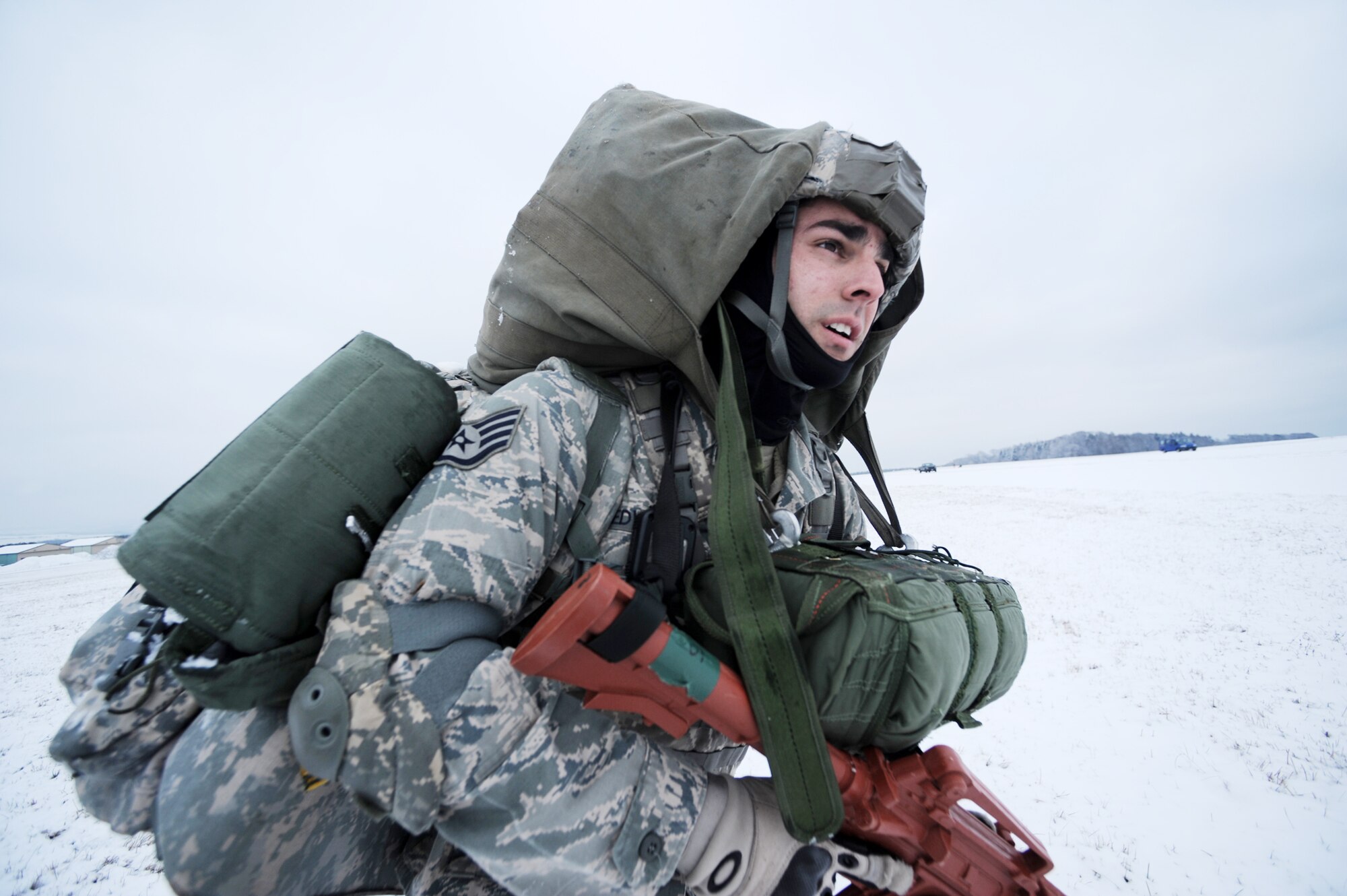 Staff Sgt. Dave Edward, with the 435th Security Forces Squadron at Ramstein Air Base, Germany, maneuvers towards a rally point at nearby Bitburg Airport Jan. 25, 2010, in preparation of Ramstein's operational readiness inspection in September. The unit is setting up bare-base operations as part of the dual-wing operational readiness exercise with the 86th Airlift Wing.   (U.S. Air Force photo/Staff Sgt. Sarayuth Pinthong)