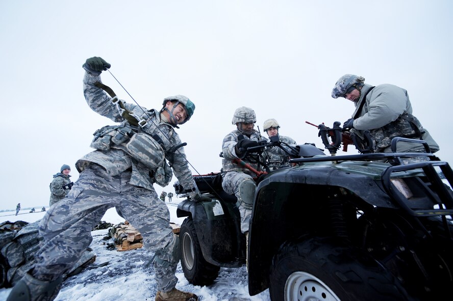 Airmen from the 435th Security Forces Squadron at Ramstein Air Base, Germany, crank the engine for their four-wheeler after an airborne insertion mission at nearby Bitburg Airport Jan. 25, 2010.  (U.S. Air Force photo/Staff Sgt. Sarayuth Pinthong)