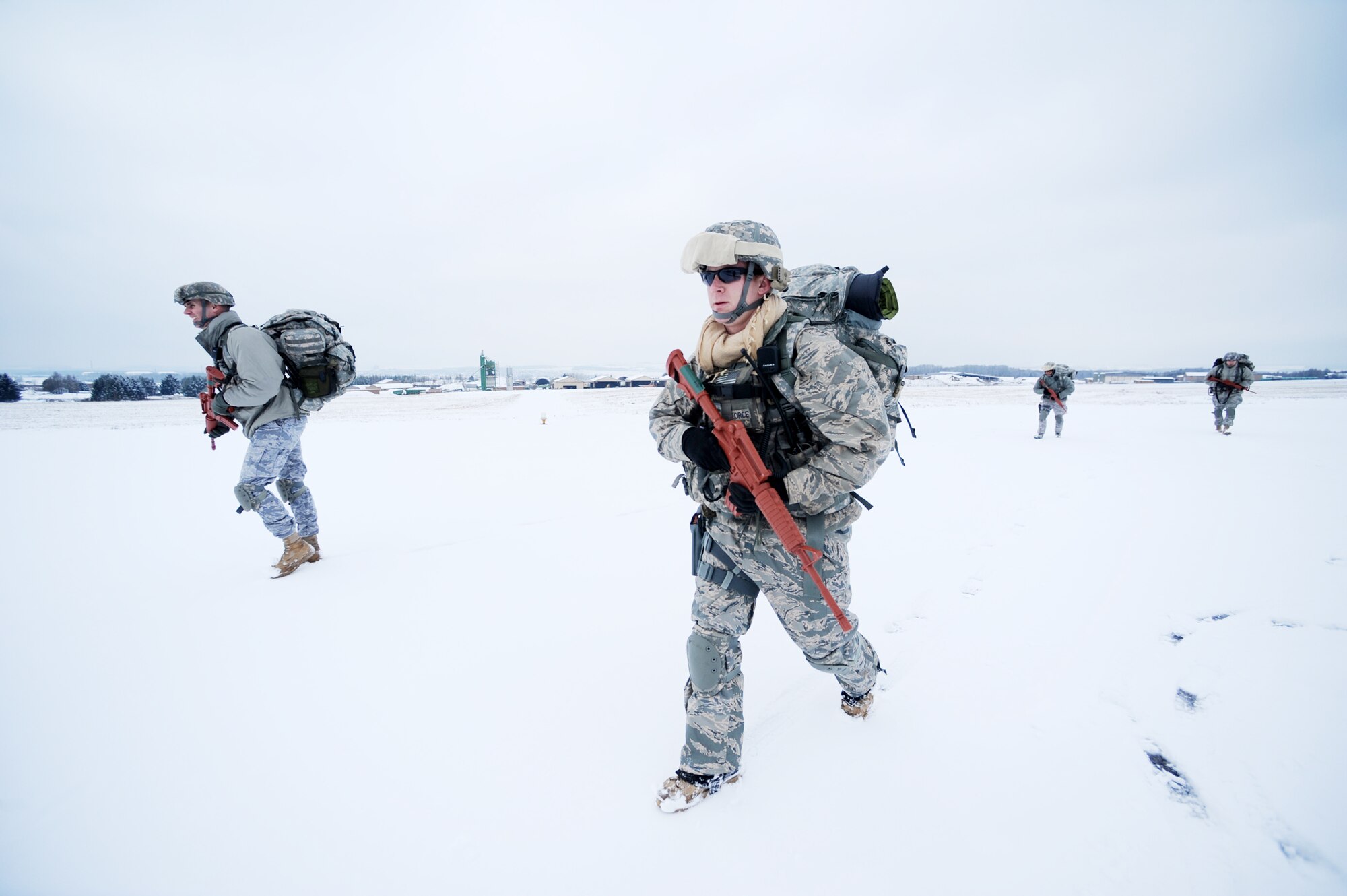 Capt. Mark Breed and Staff Sgt. John Gaunt from Ramstein Air Base, Germany, make their way to the rally point after an airborne insertion mission at nearby Bitburg Airport Jan. 25, 2010.  (U.S. Air Force photo/Staff Sgt. Sarayuth Pinthong)