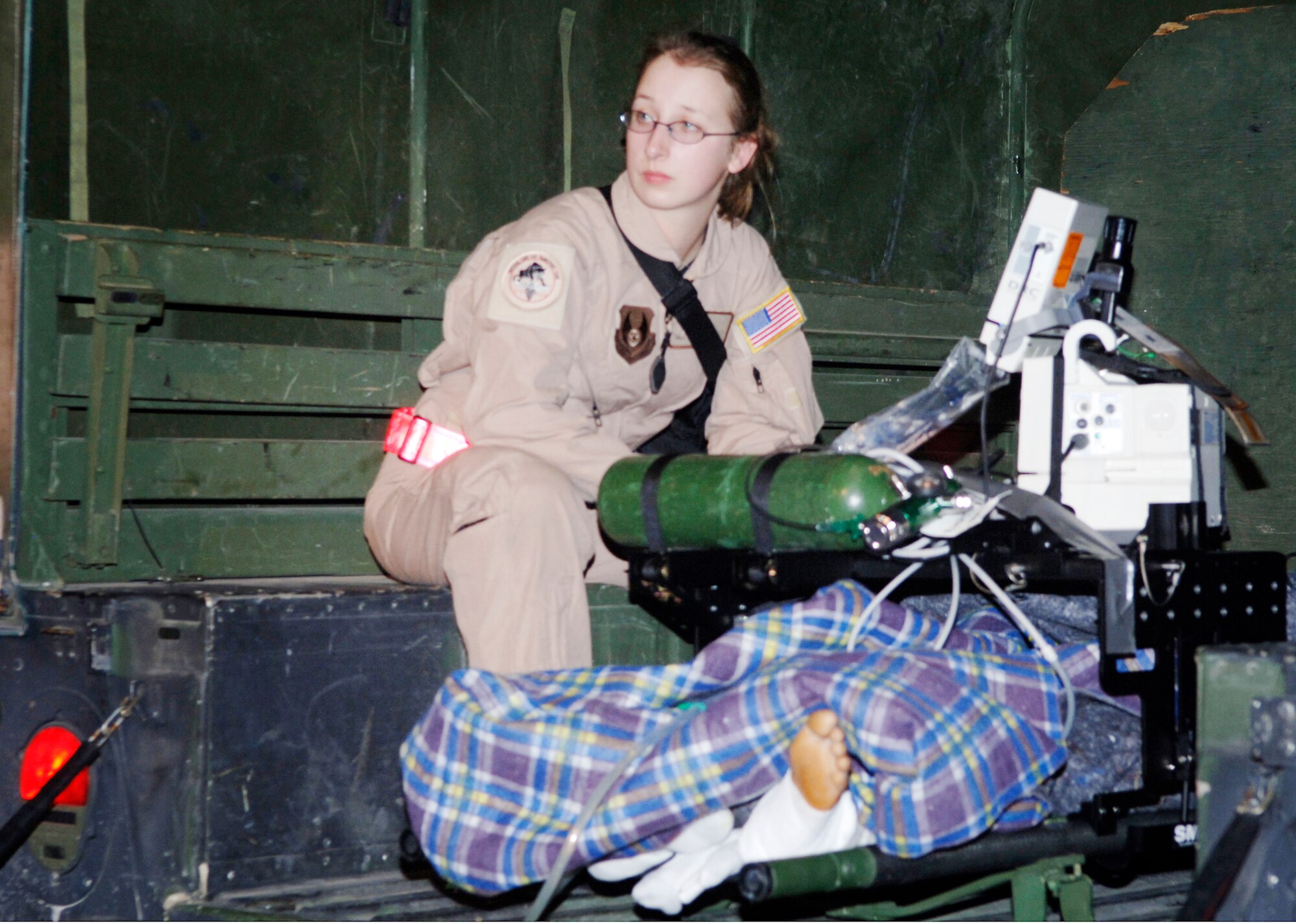 Senior Airman Brooke Lohr, a cardiopulmonary technician and critical care air transport team member, prepares a patient for aeromedical evacuation from Port-au-Prince, Haiti, to Fort Lauderdale, Fla., Jan. 24, 2010. Senior Airman Lohr is deployed from the 88th Medical Group at Wright-Patterson Air Force Base, Ohio (U.S. Air Force photo/2nd Lt. Anastasia Wasem)