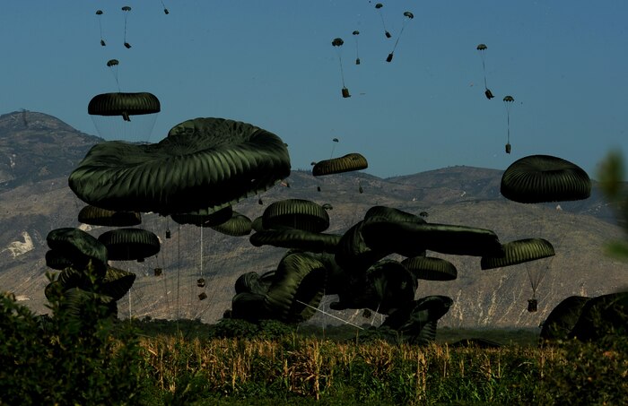Bundles of food and water are air delivered to the outlying area of Port-au-Prince, Haiti, Jan. 23, 2010. Approximately 14,000 bottles of water and 14,500 Meals Ready to Eat were in included in the air delivery. (U.S. Air Force photo by Tech. Sgt. James L. Harper Jr./Released)